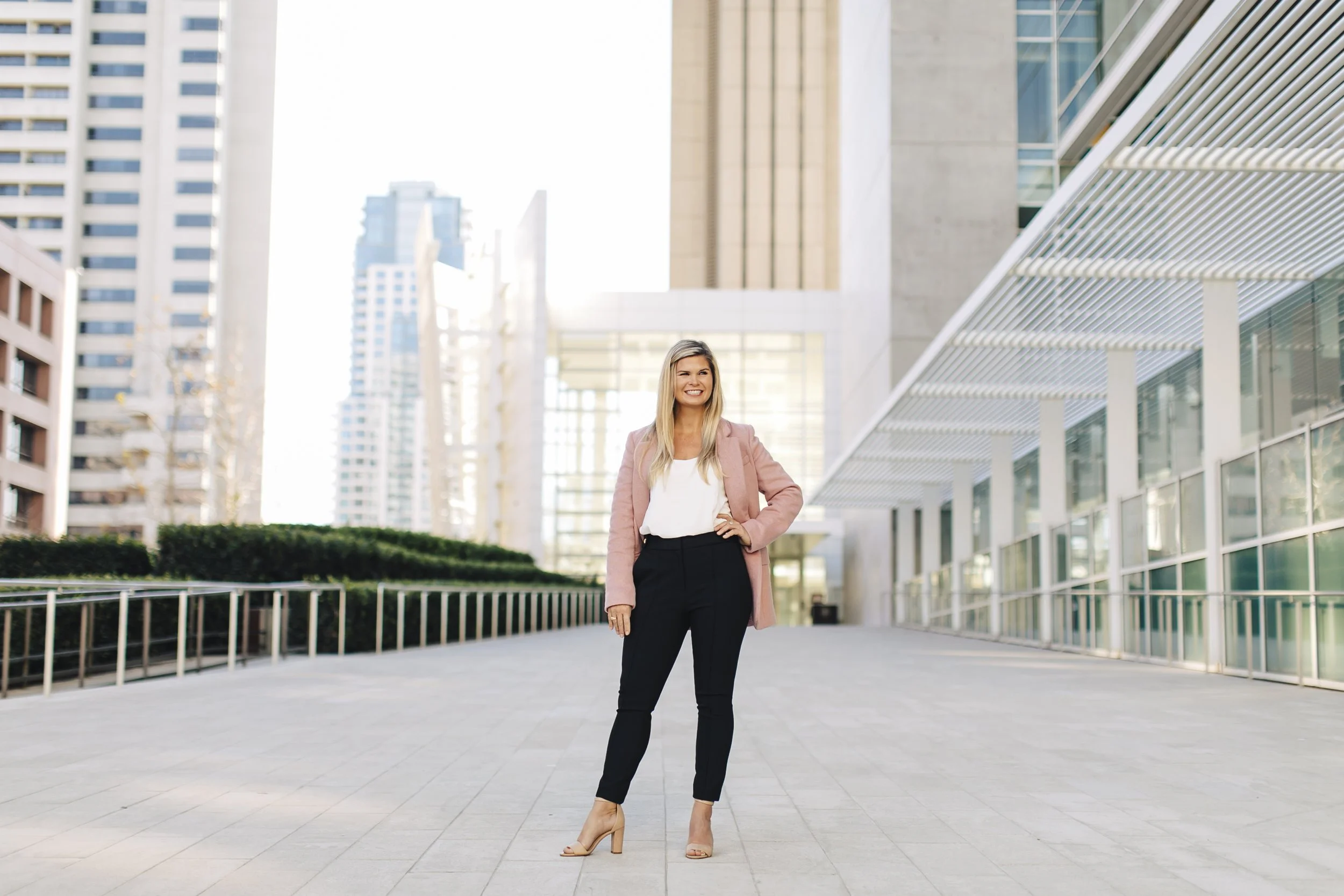 Career Coach, Kate Rosenberg, standing confidently in downtown San Diego smiling with her hand on her hip