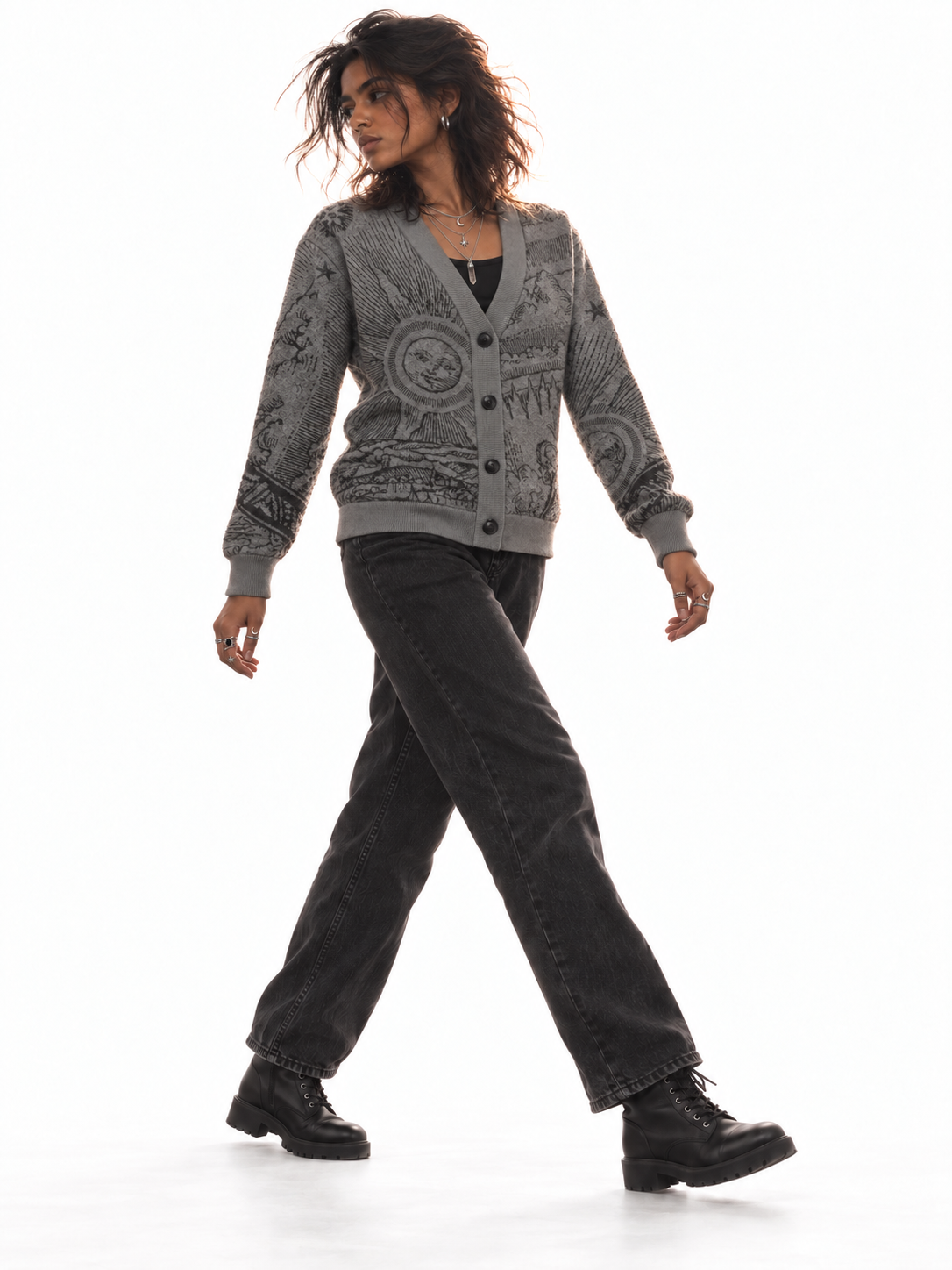 The Anderson cardigan styled with black jeans and lace-up boots on a walking model