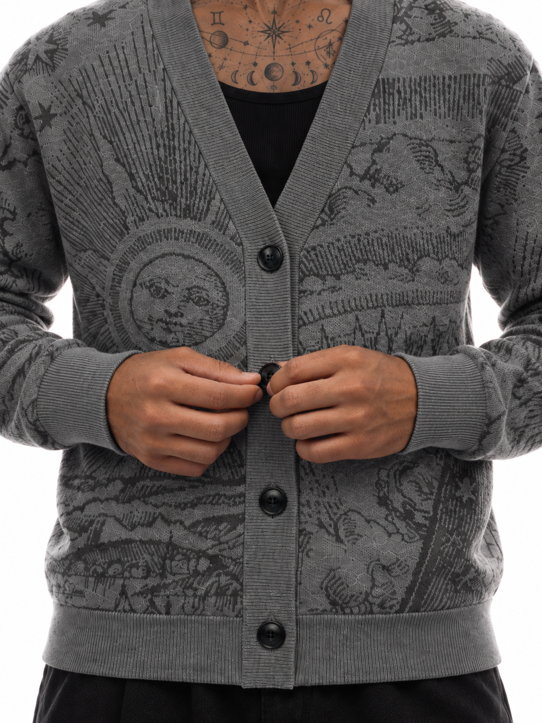Close-up of The Anderson cardigan showing the sun motif, V-neck, and black buttons