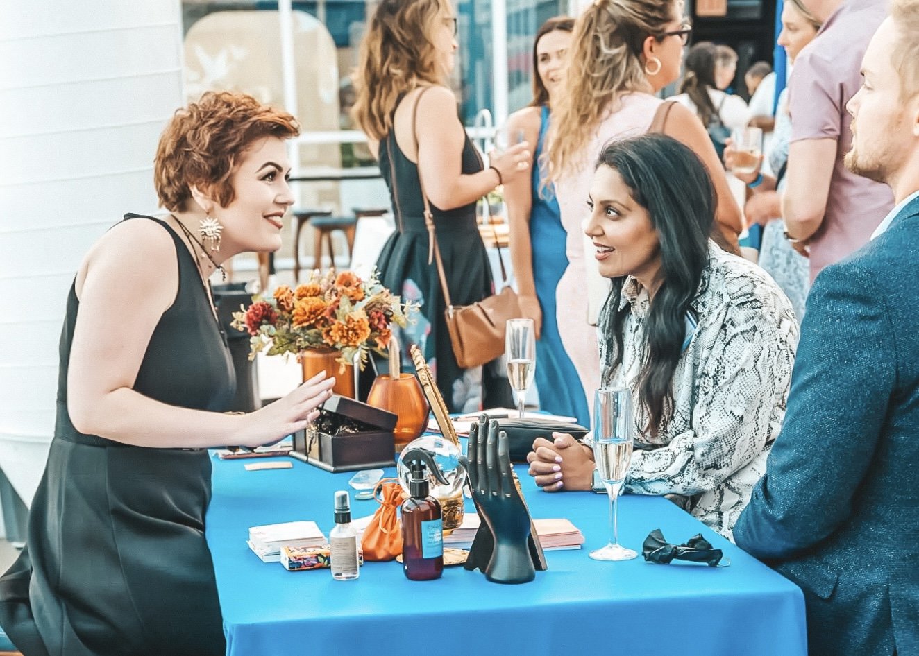 Madame Creatrix smiles at her clients while giving a reading at the DNC fundraiser for the Illinois Democrats for the House.