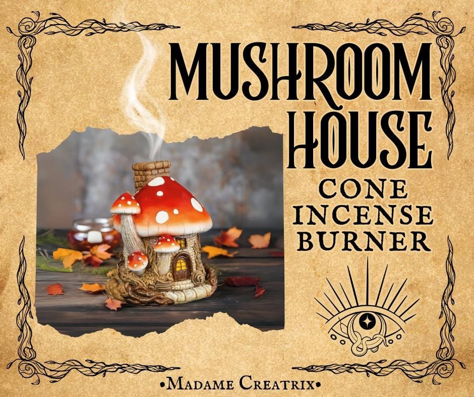 Whimsical mushroom house incense burner with colorful polyresin design, smoke emerging from the chimney.