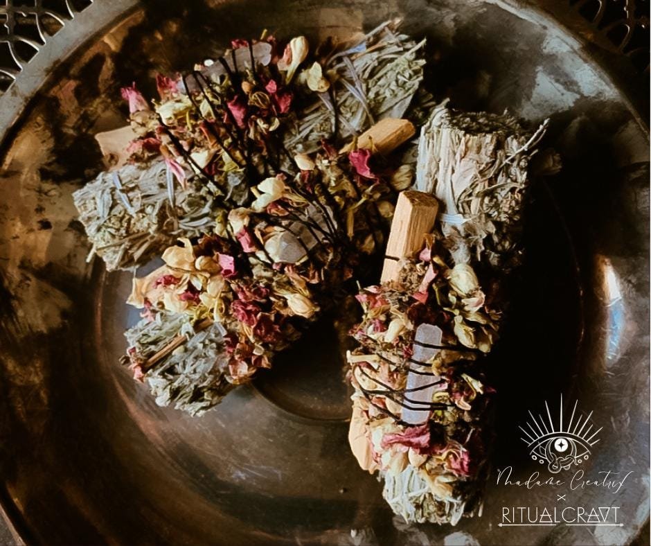 Handcrafted Mugwort and Palo Santo ritual bundle with a crystal and herb blend, arranged on a natural background.