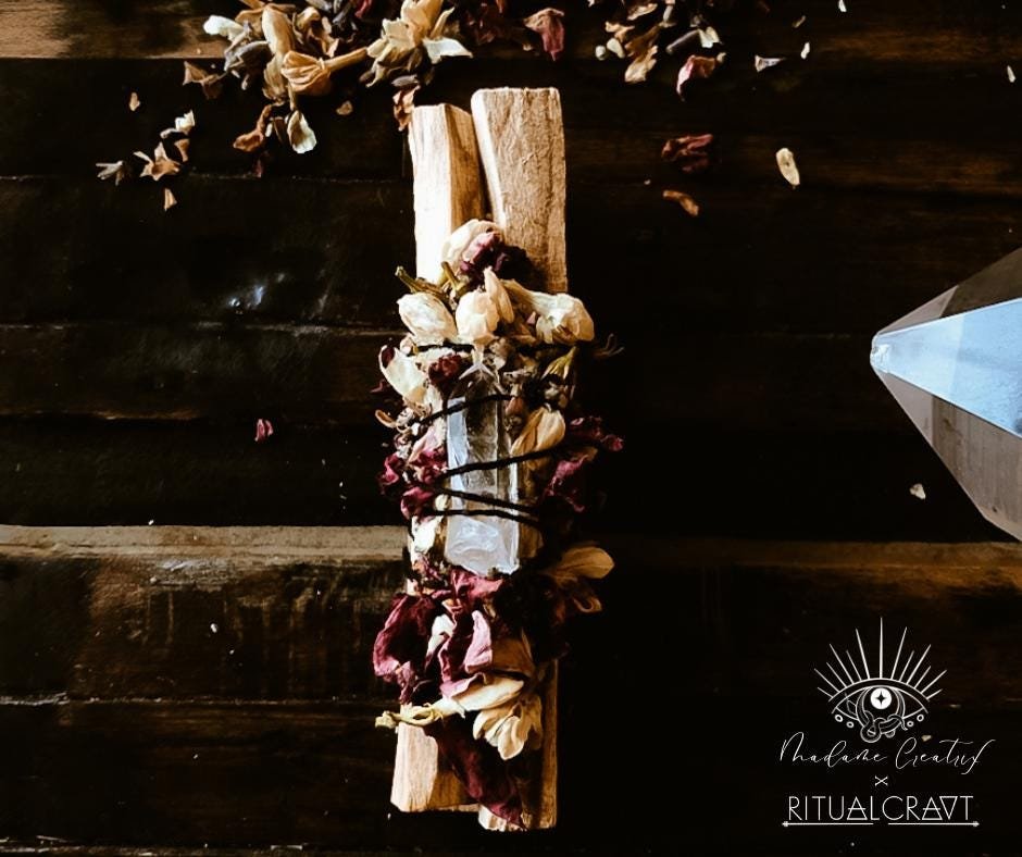 Palo Santo smudge sticks paired with a crystal and herbs, ready for energy cleansing and blessings.