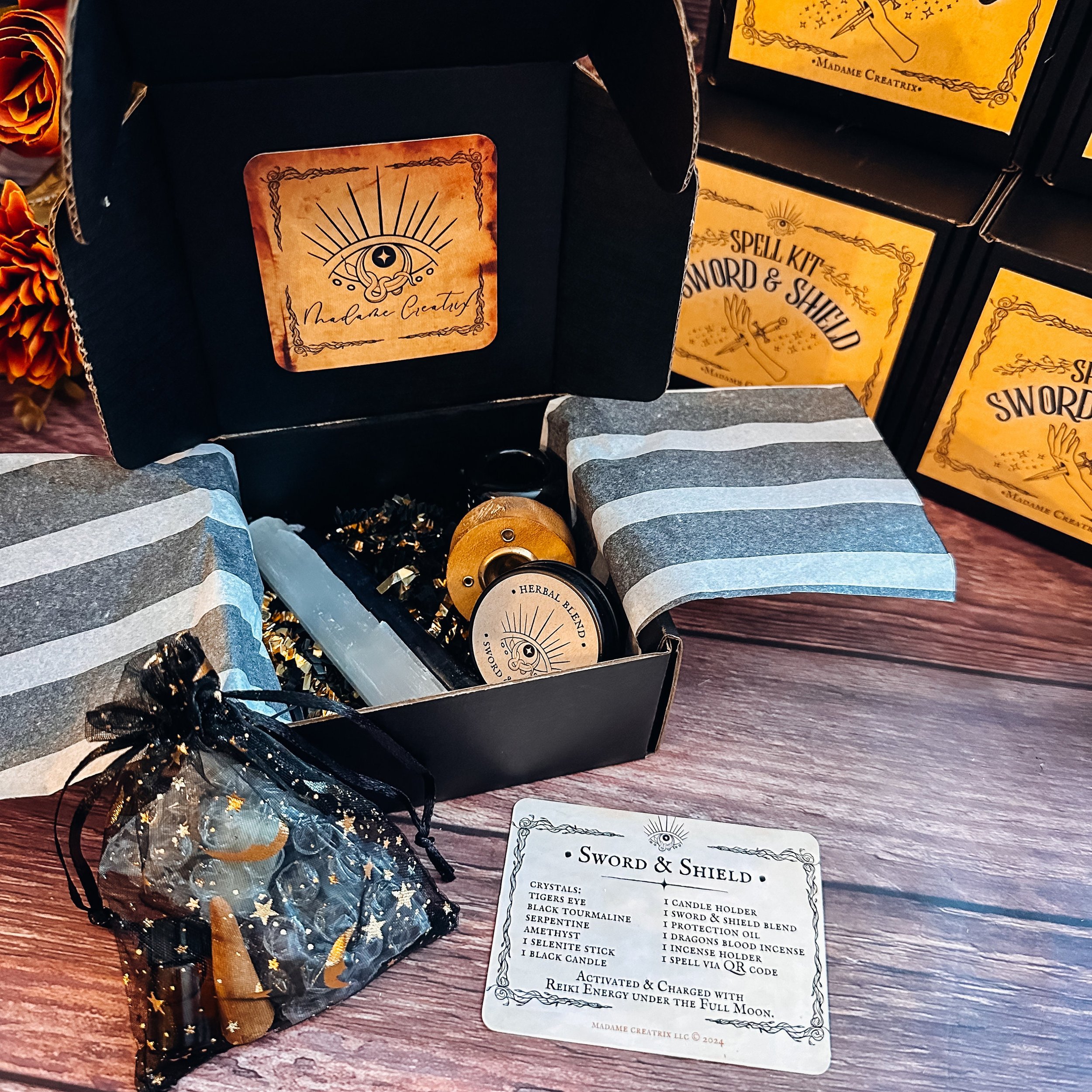 Sword & Shield Spell Kit contents: crystals, candle, herbal blend, oil, incense, and holder displayed beautifully.