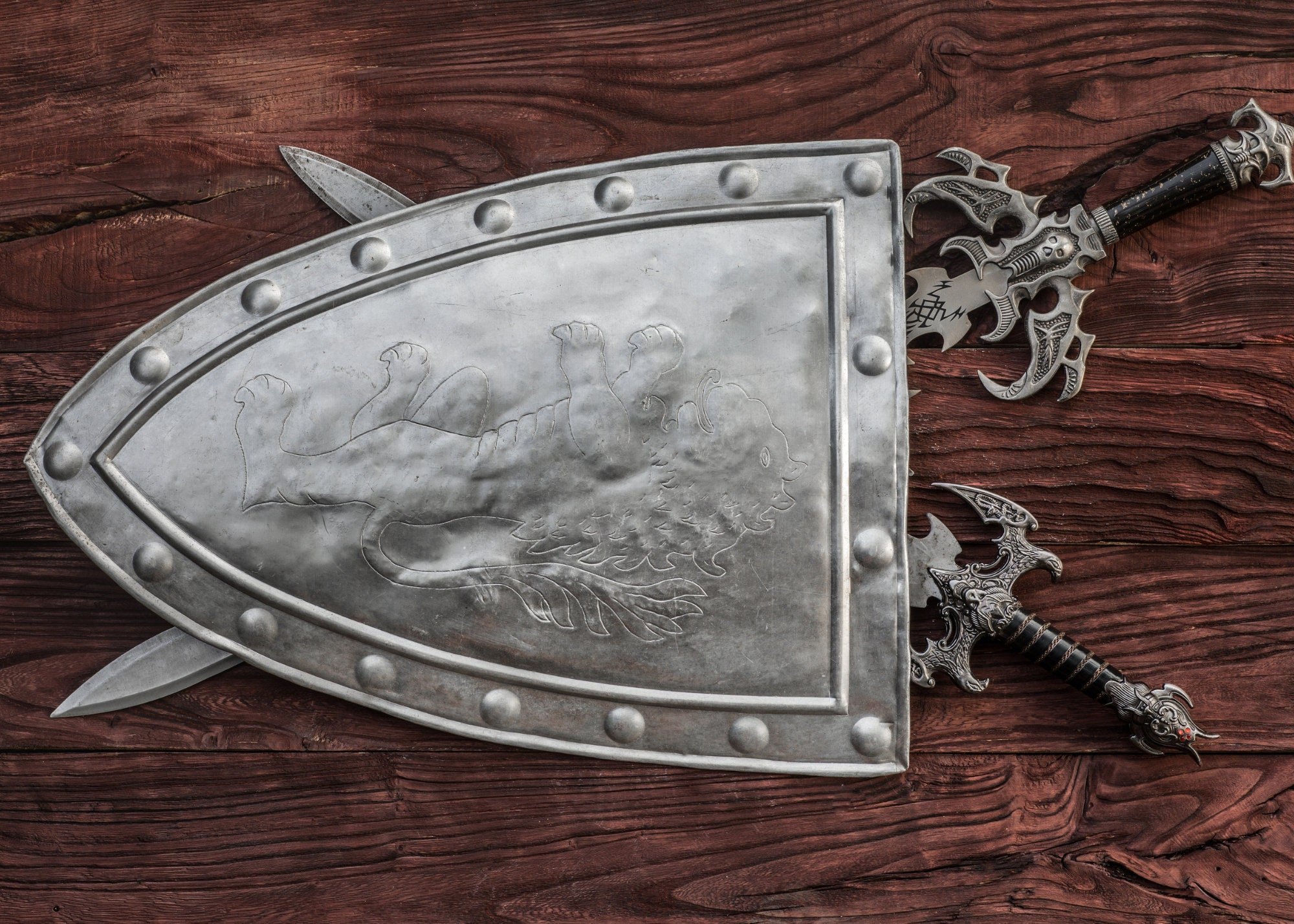 Symbolic medieval armor, chain mail, sword and shield for protection, offense and defense.