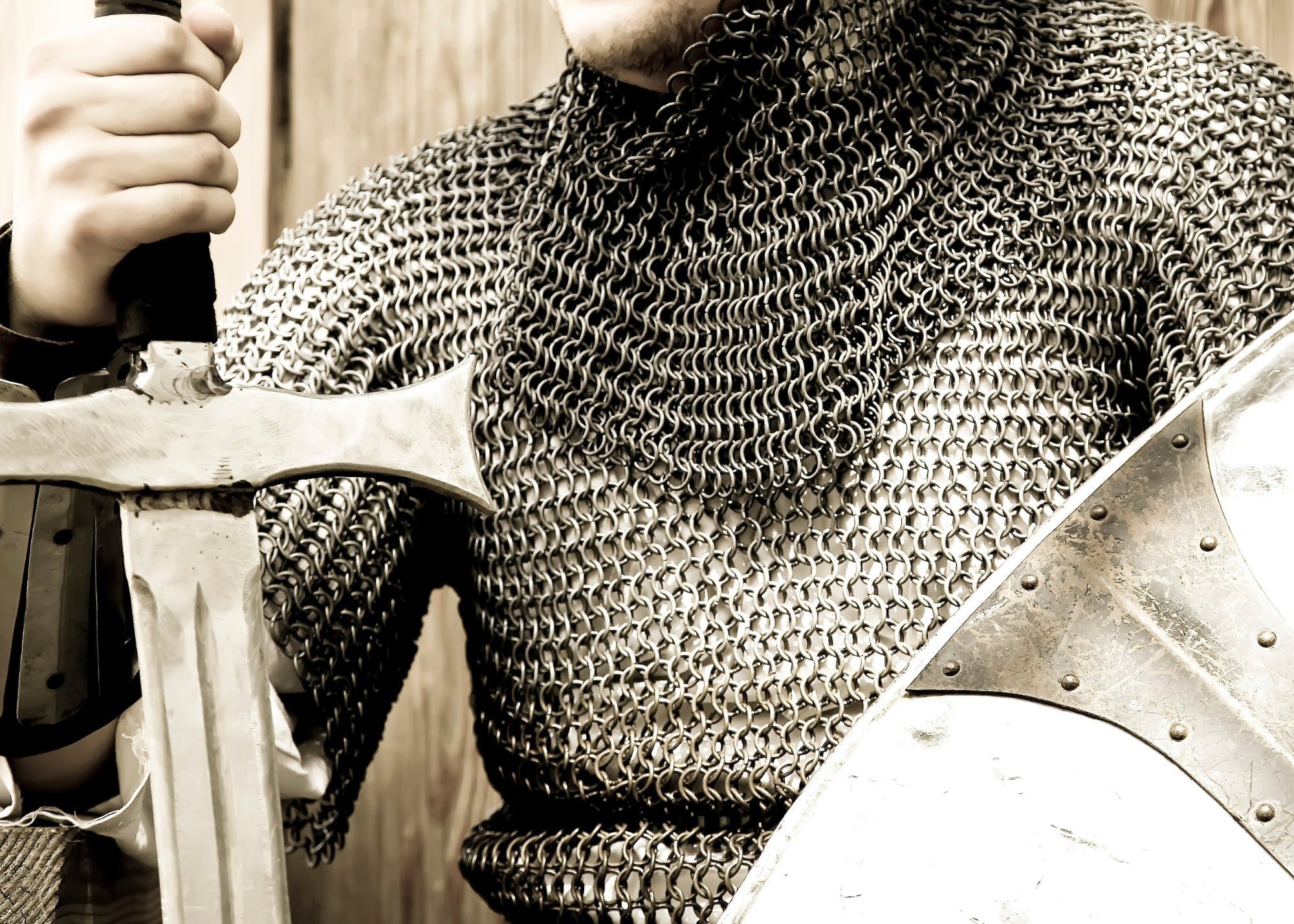 Symbolic medieval armor, chain mail, sword and shield for protection, offense and defense.