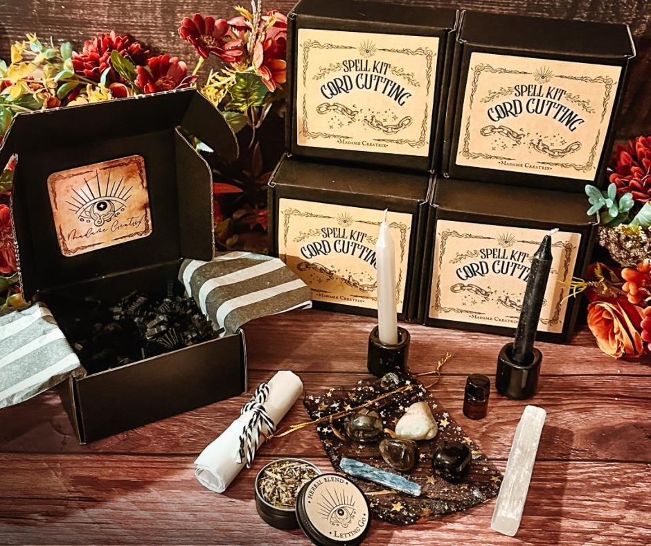 Cord Cutting Spell Kit: crystals, black and white candles, cord, herbal blends, oil, and contract beautifully displayed.