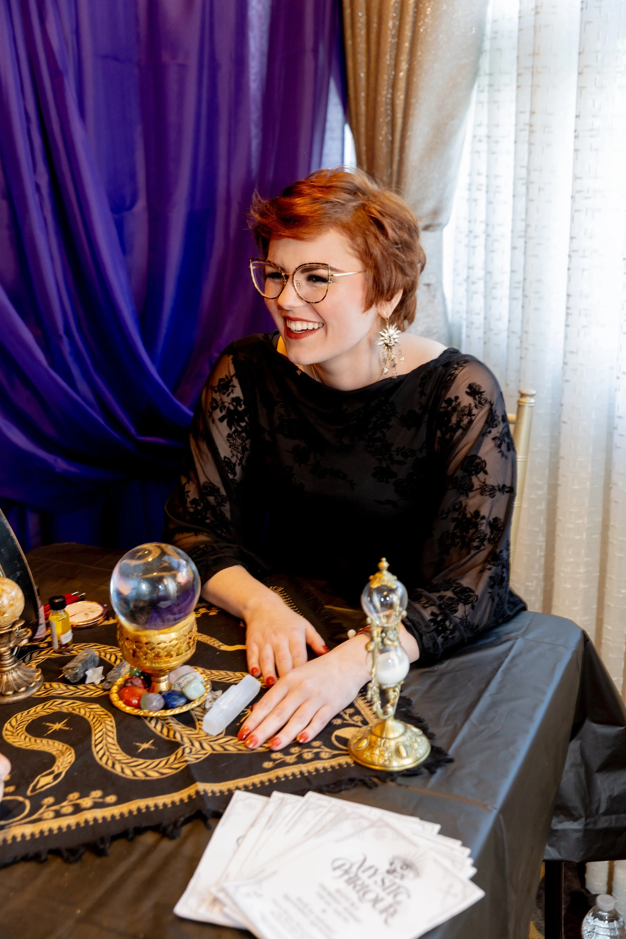 Madame Creatrix smiles looking off camera while at a fundraiser.