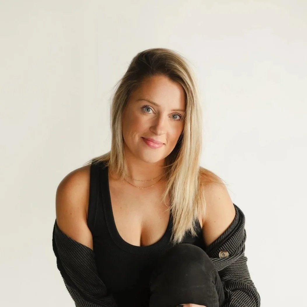 A witch working magic, we see a hand pouring herbs into a cauldron with two candles beside it.