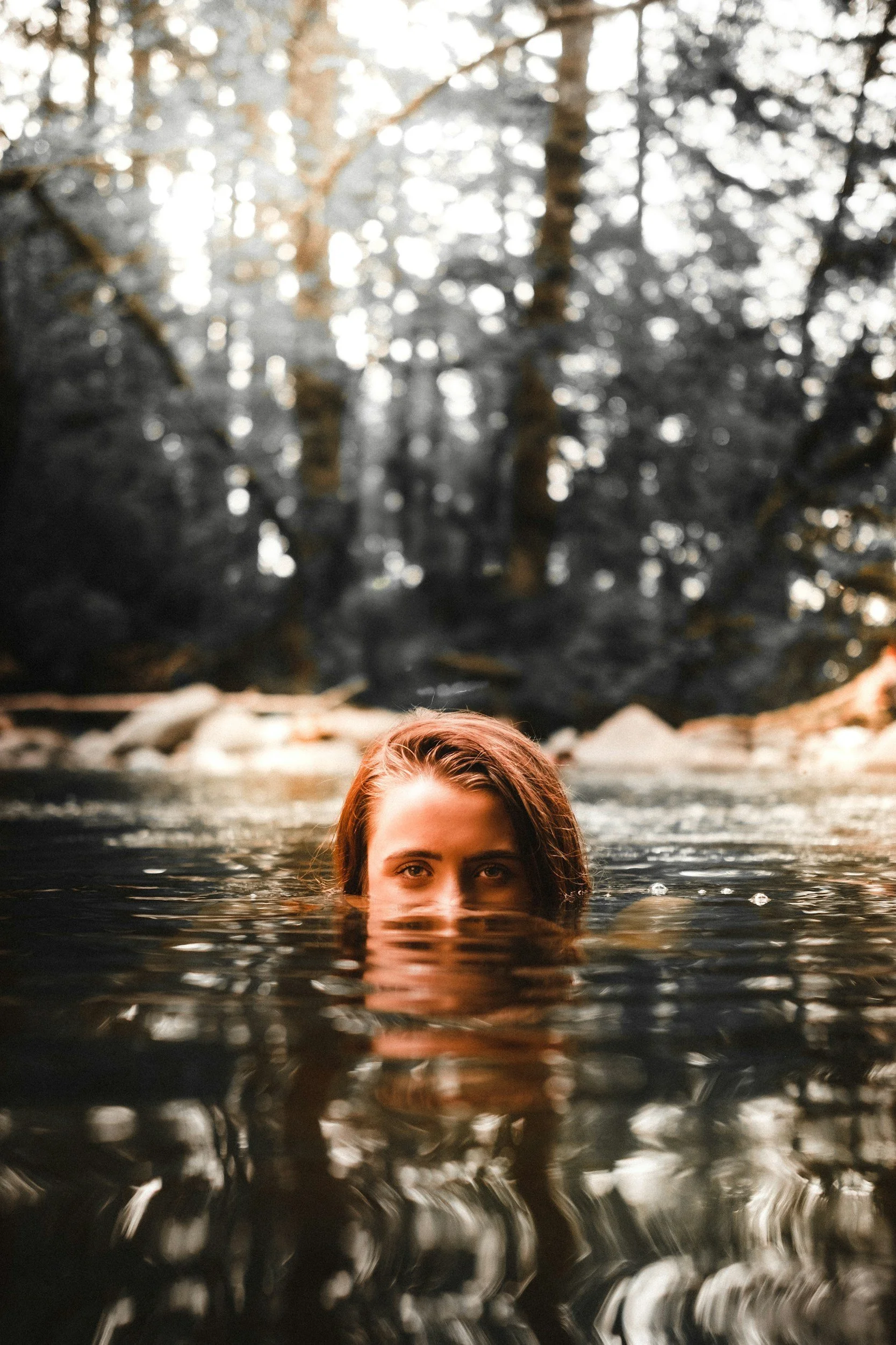 Woman swimming in a lake, trying to overcome burnout - therapy for people pleasing