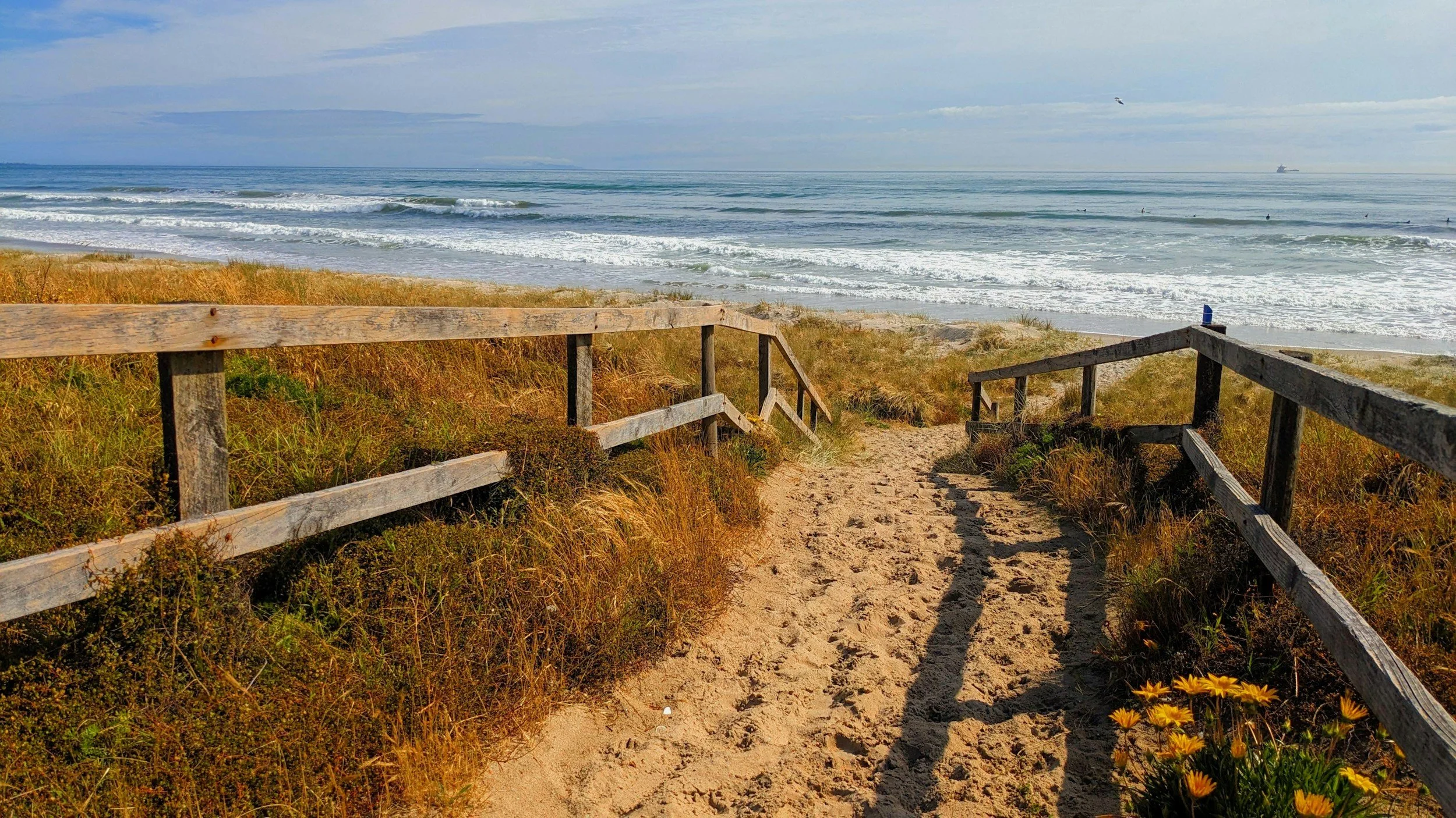 A sandy path down to the beach and ocean, a good place to offer yourself some self-compassion