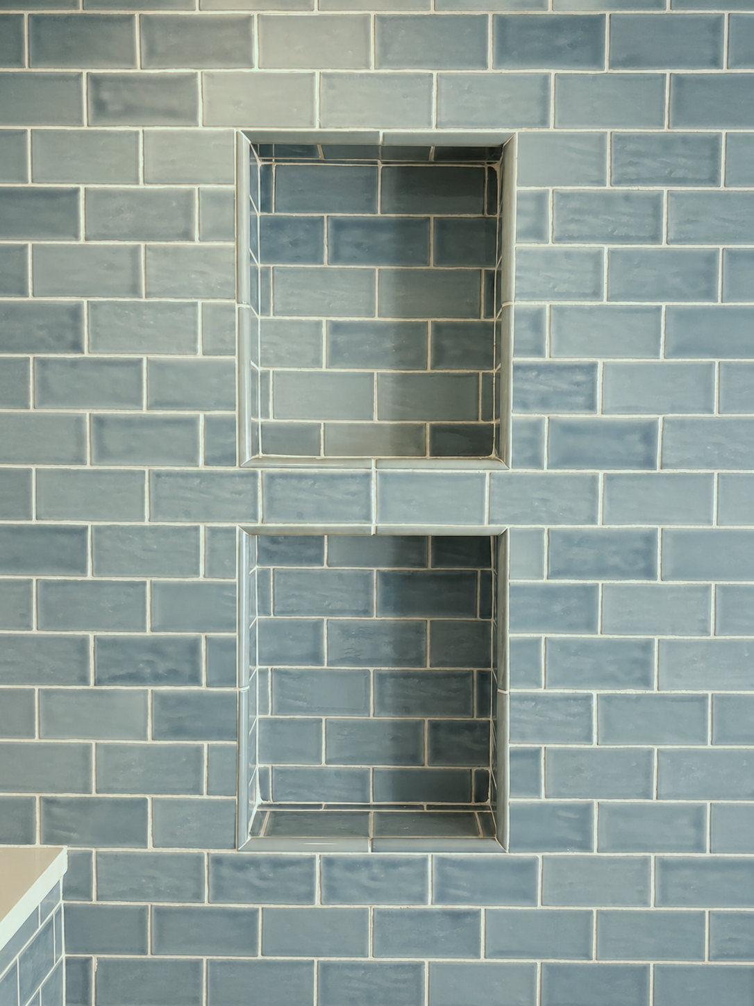 A double niche in the shower provides a "his and hers" functionality.