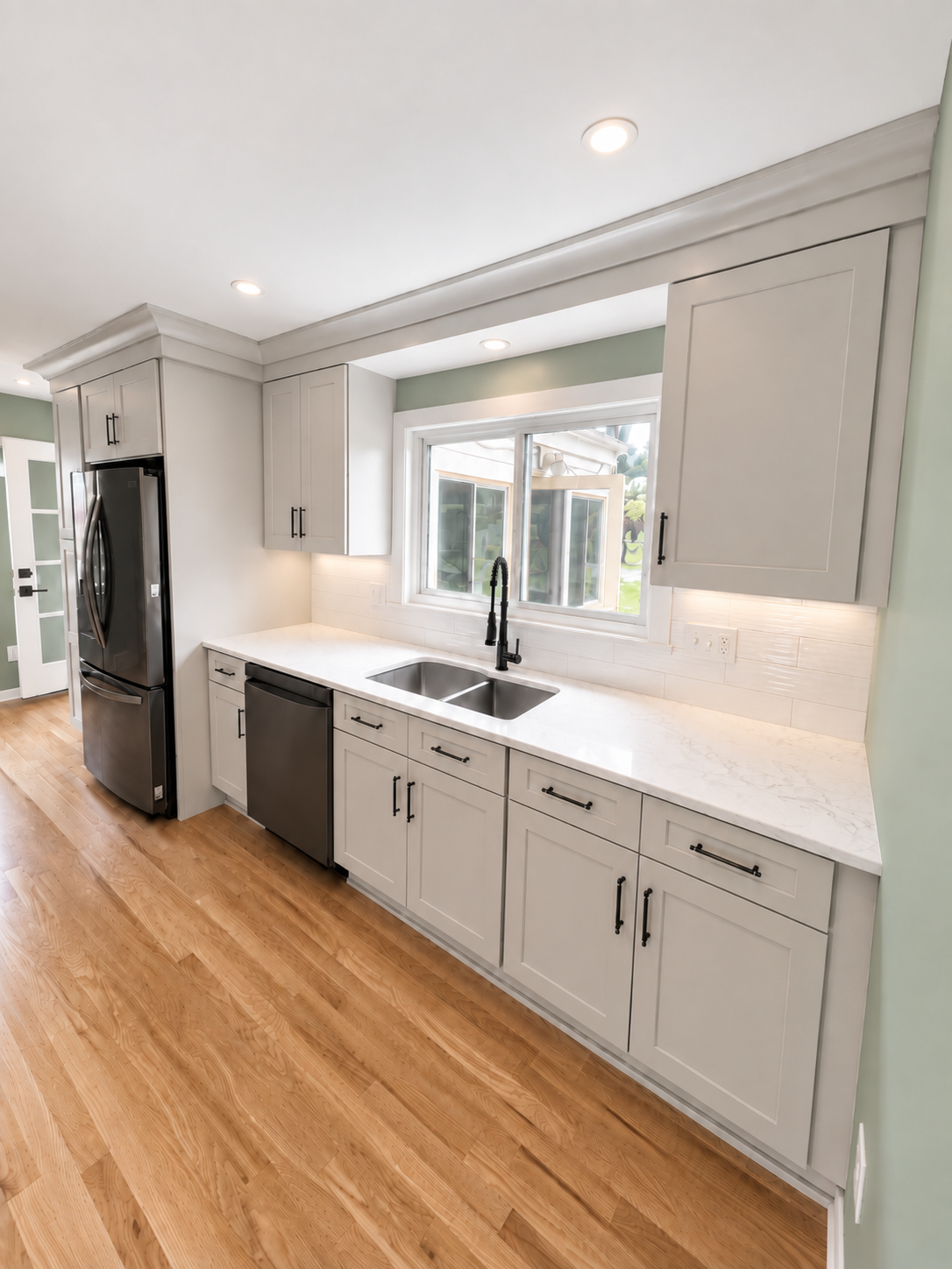Remodeled kitchen with spacious sink wall.