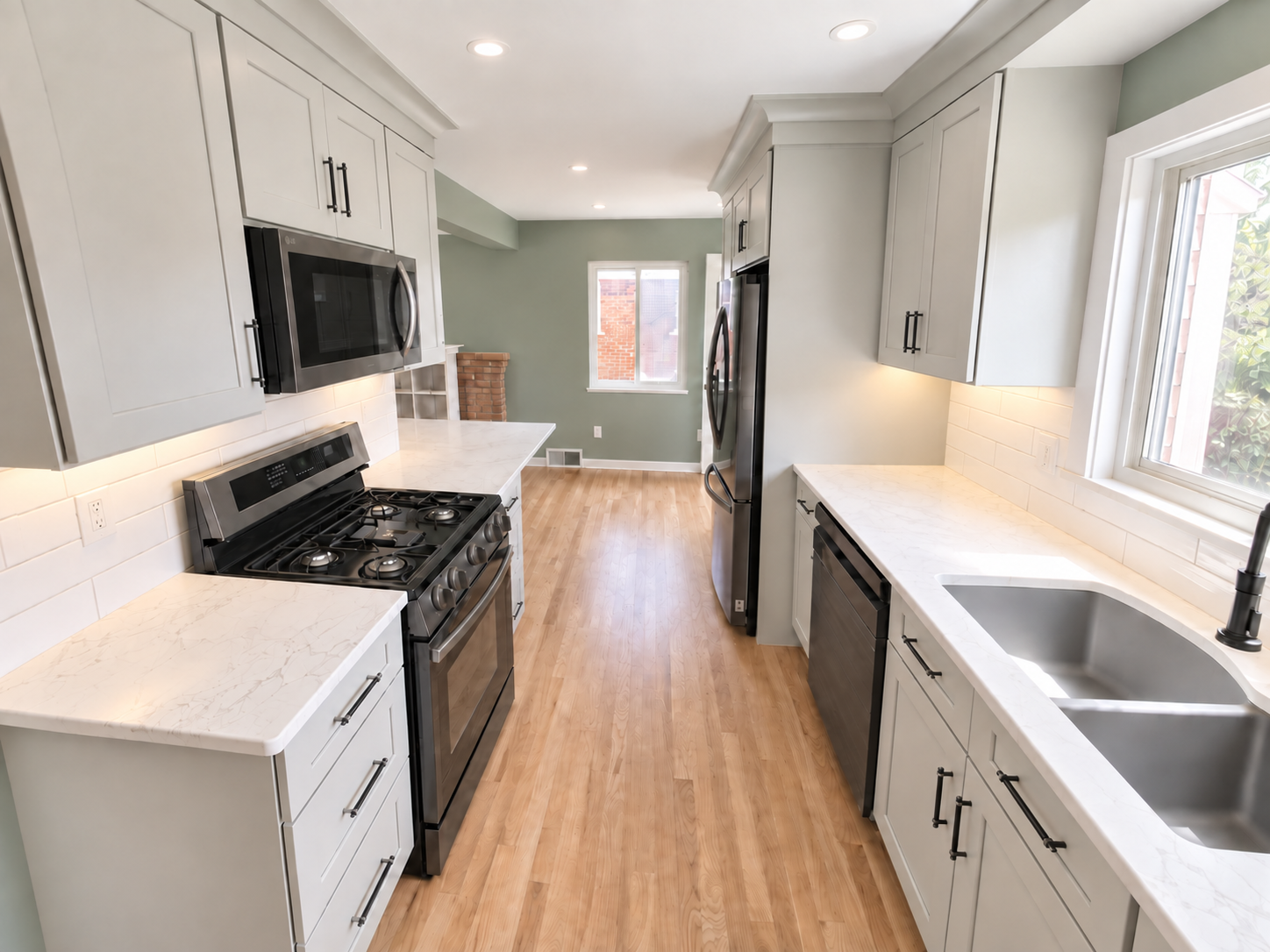 Classic shaker cabinets with black stainless steel appliances.