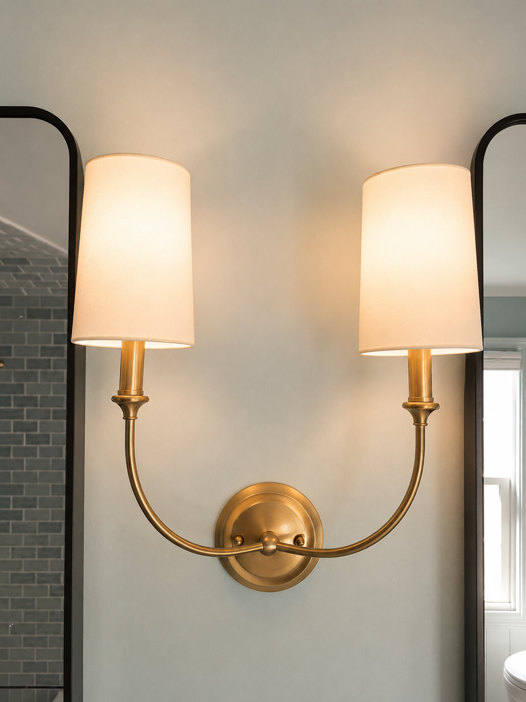 A decorative sconce in modern brass.