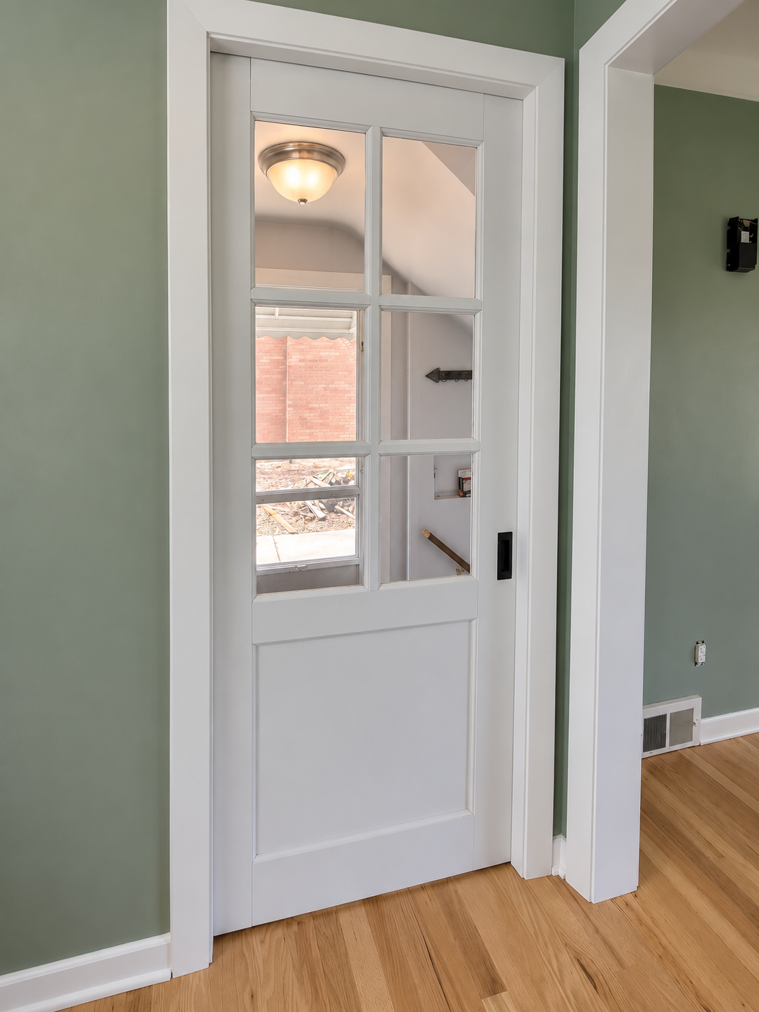 Pocket door with 6 windows letting in natural light.