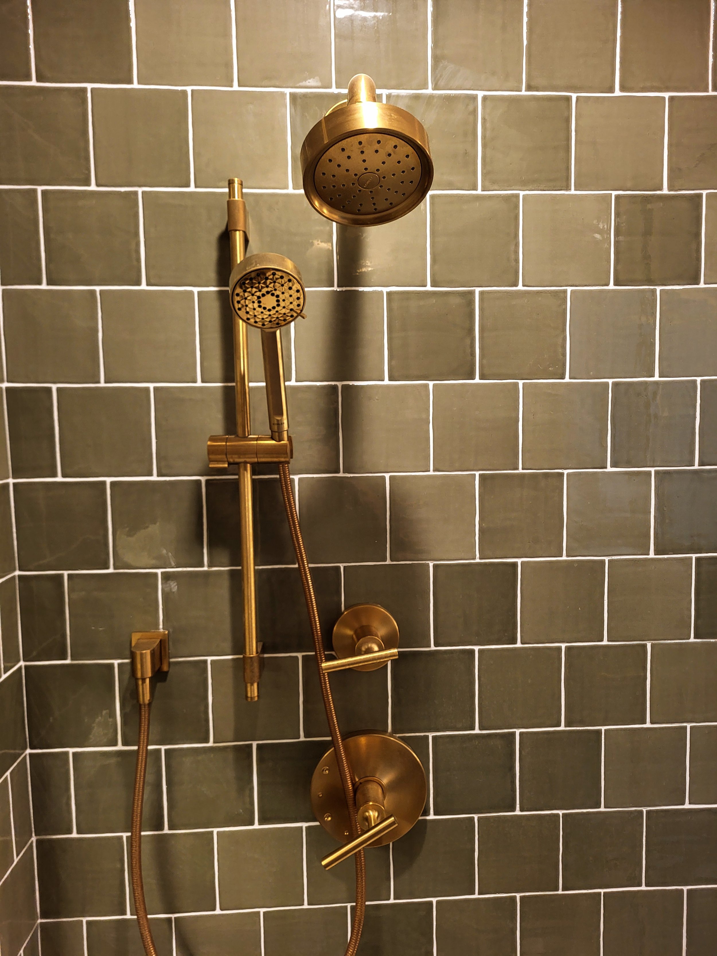 Modern brass shower head and handheld.