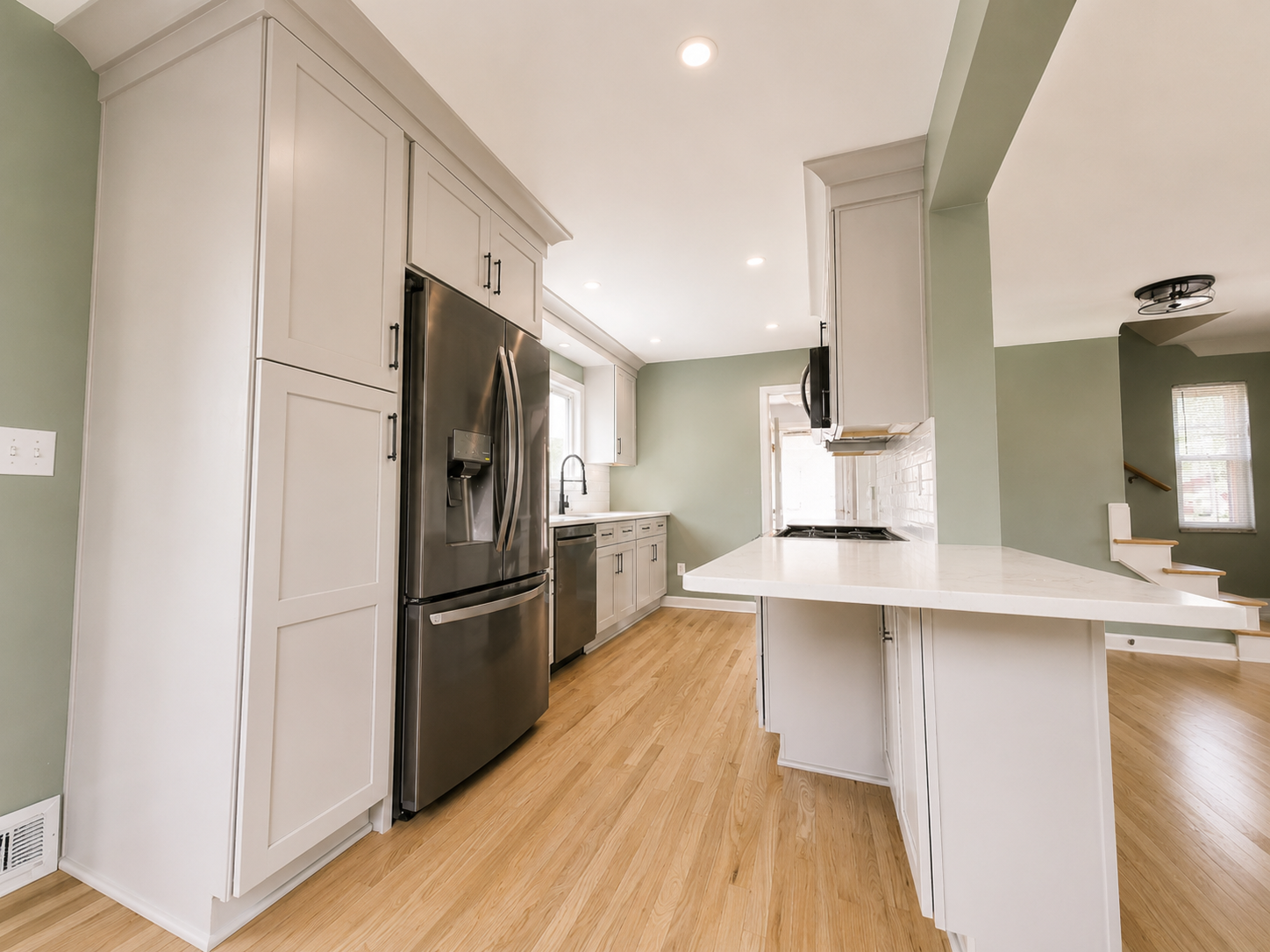 Opened kitchen layout with new cabinetry and appliances.