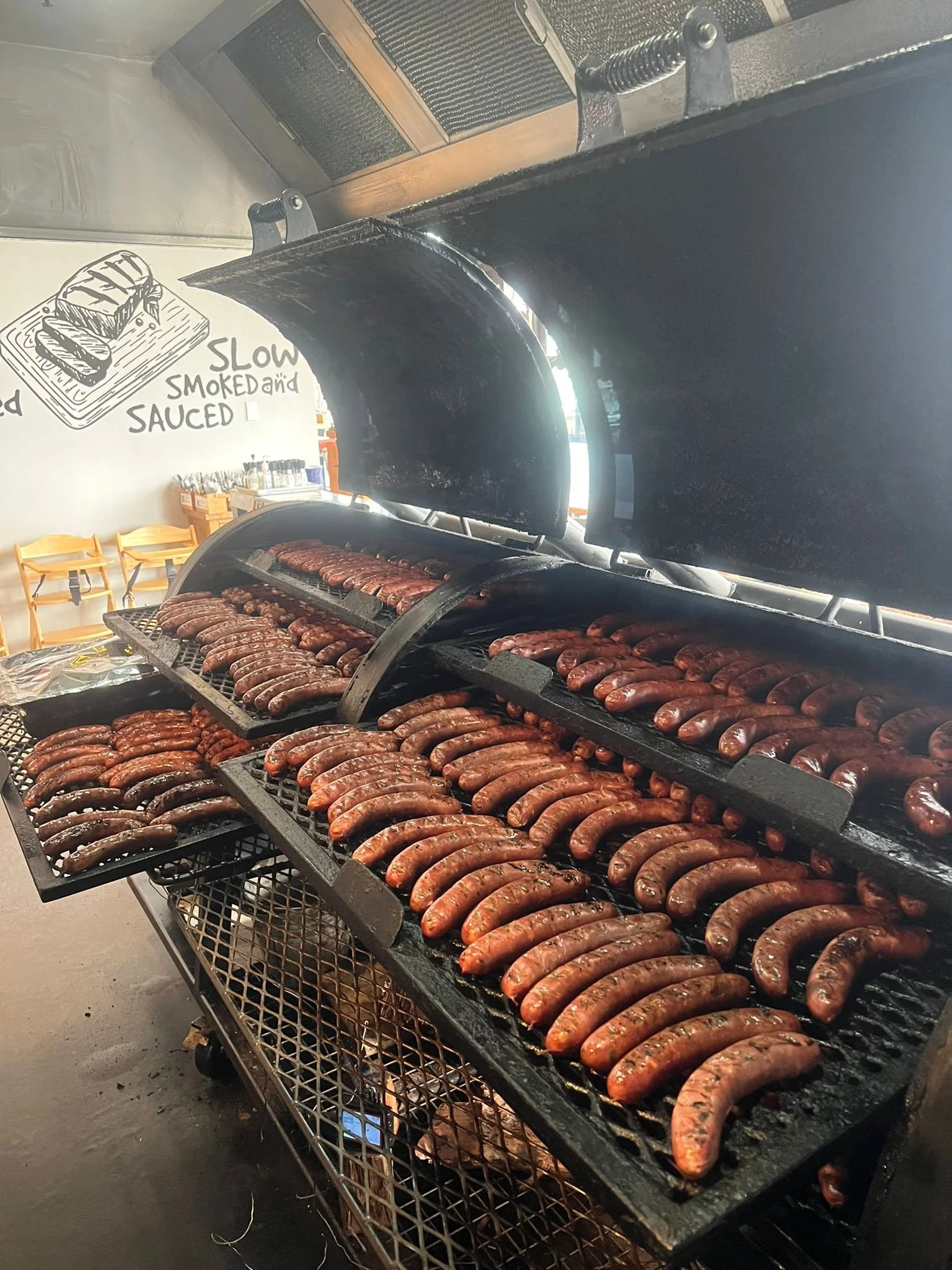 House-smoked jalapeño kransky sausage, prepared in our onsite smoker at Moo Moo Smokehouse & Grill in Auckland.