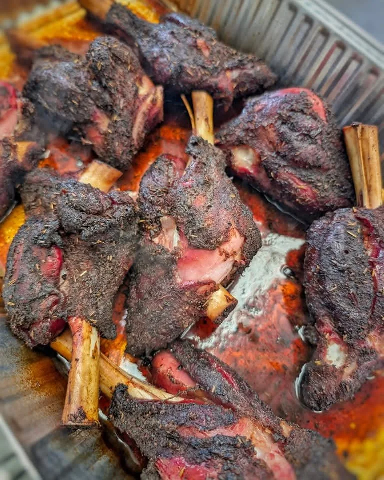 Slow-cooked lamb shank with rich seasoning and tender meat, prepared at Moo Moo Smokehouse & Grill in Auckland.