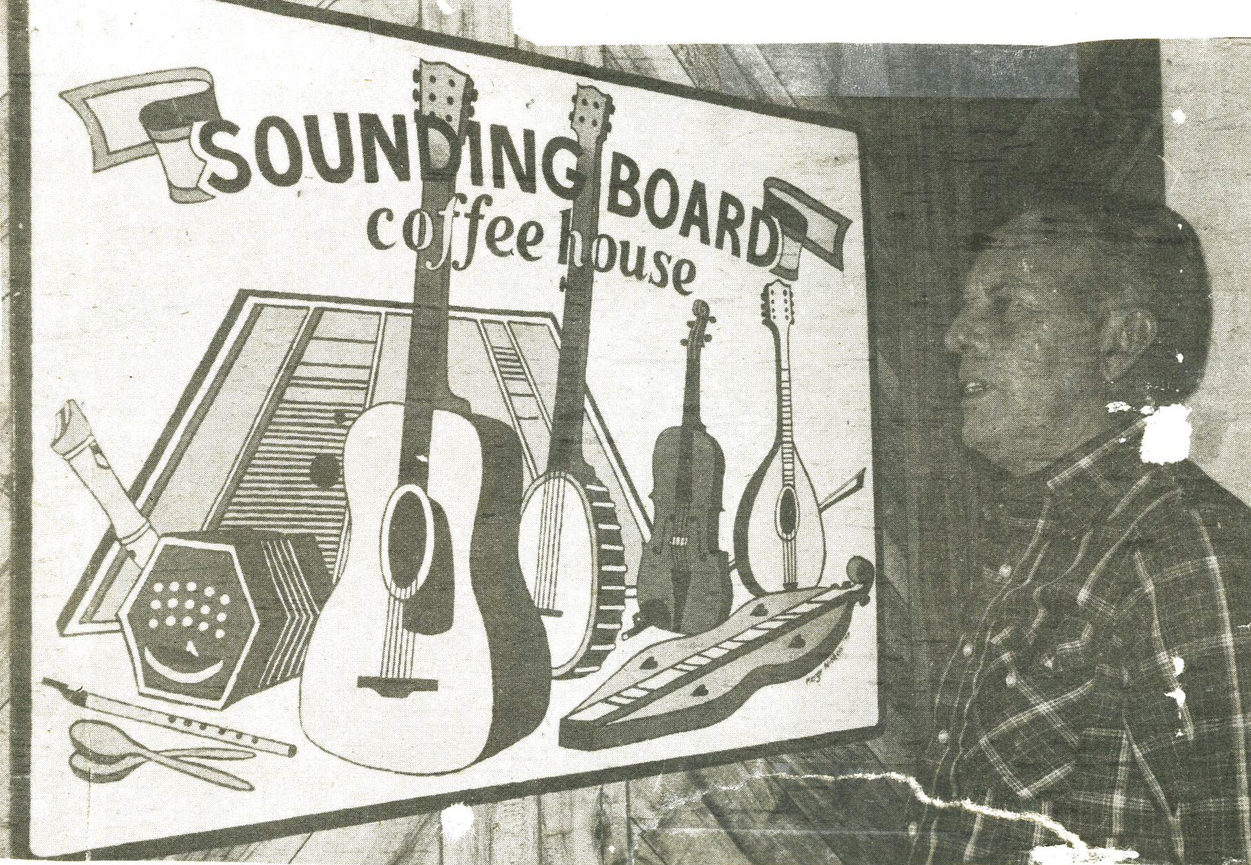 Len Domler in front of the iconic wooden sign that goes out at our concerts. Artwork by Marge Nichols.