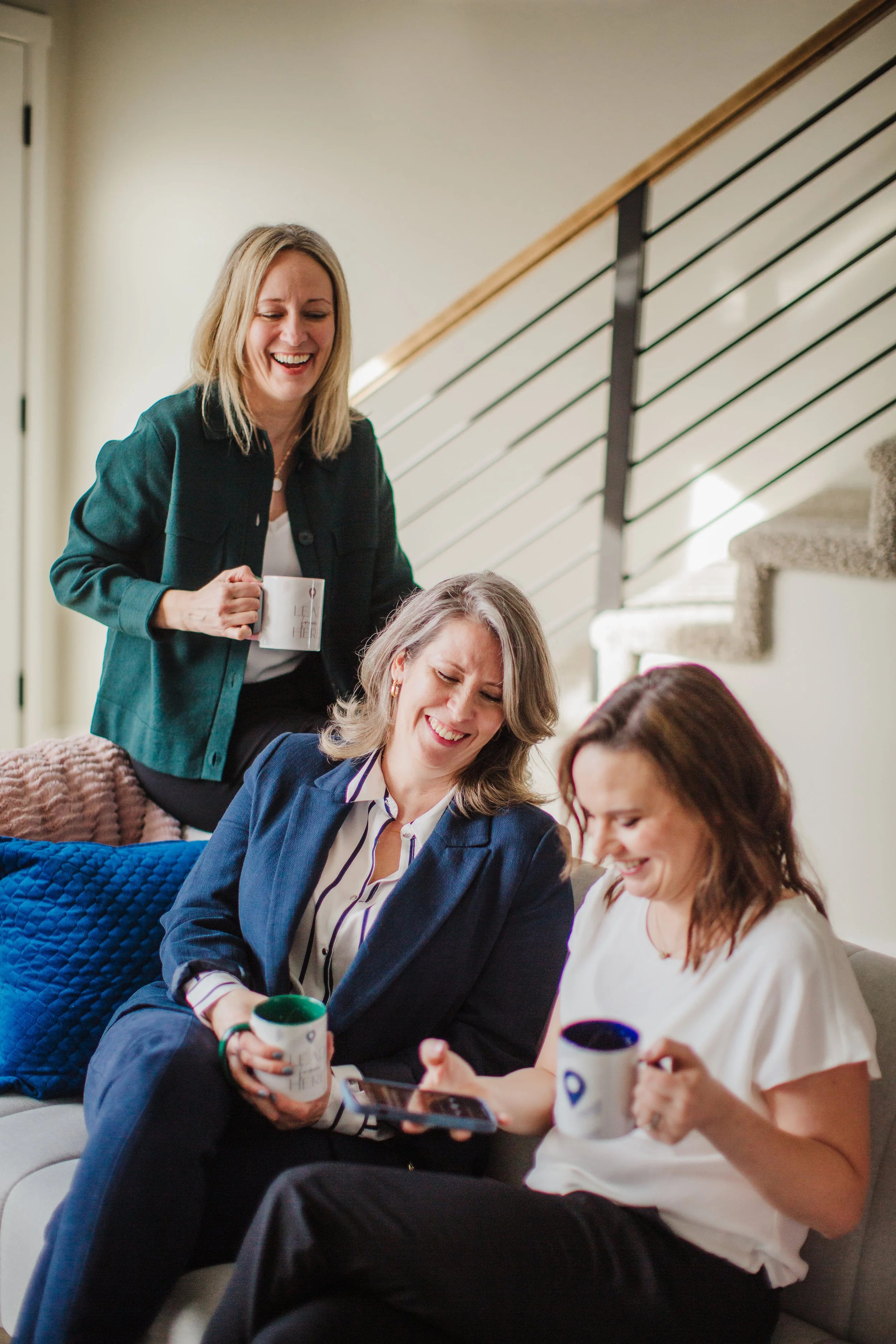 Laughing co-workers drinking coffee