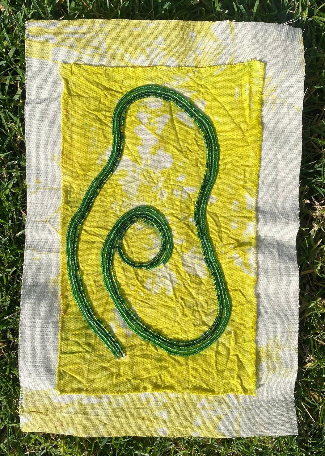 “A Vision of Fertility”, 2024, Mixed media, 100% cotton, glass beads, cotton thread, natural dye, 9x13in
