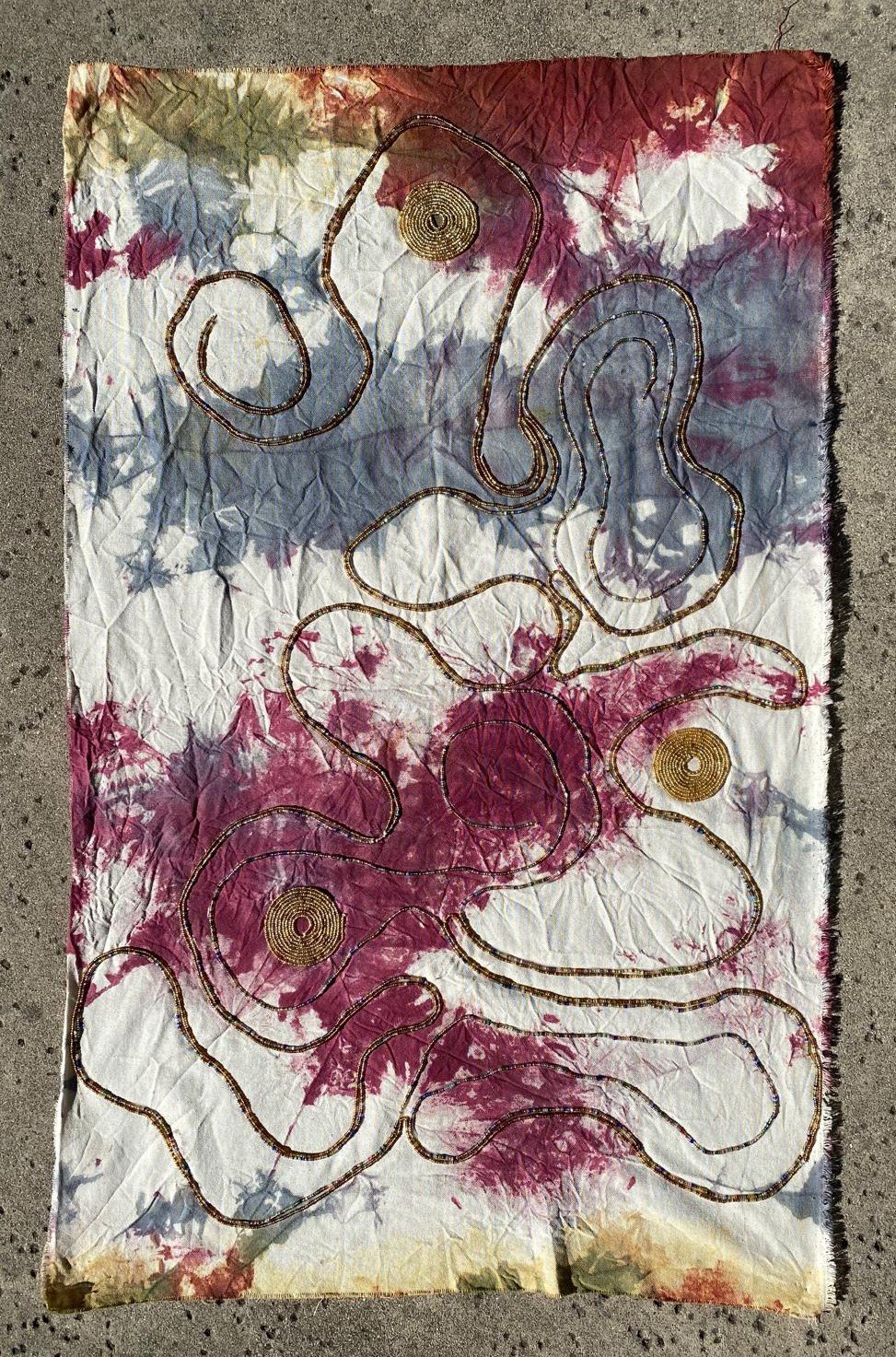 “Collective Heart, 2025, Mixed media, natural tie dyed 100% cotton, glass beads, cotton thread, 3x2 ft / 35x22 in