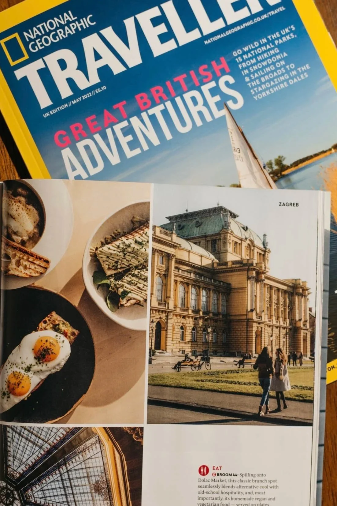 Cover of National Geographic Travel magazine featuring the headline 'Great British Adventures' and a photograph of a sailing boat on a river or lake with a clear blue sky.