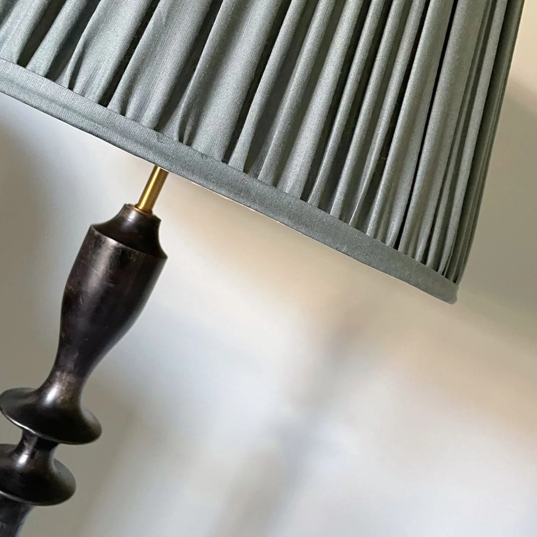 This is one of those details we come back to time and time again.

A pleated shade might seem like a small choice, but it completely changes how the light sits in a room &mdash; softening it, adding texture, and creating those gentle shadows that giv