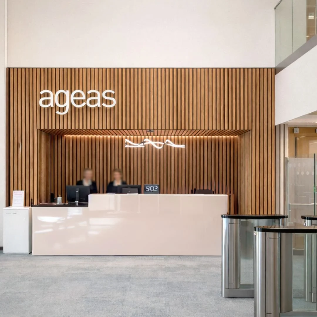 Alongside our residential work, we partner with commercial and hospitality clients to shape spaces that reflect their brand and support how they operate day to day.

This reception for Ageas was redefined through a clear concept direction &mdash; int