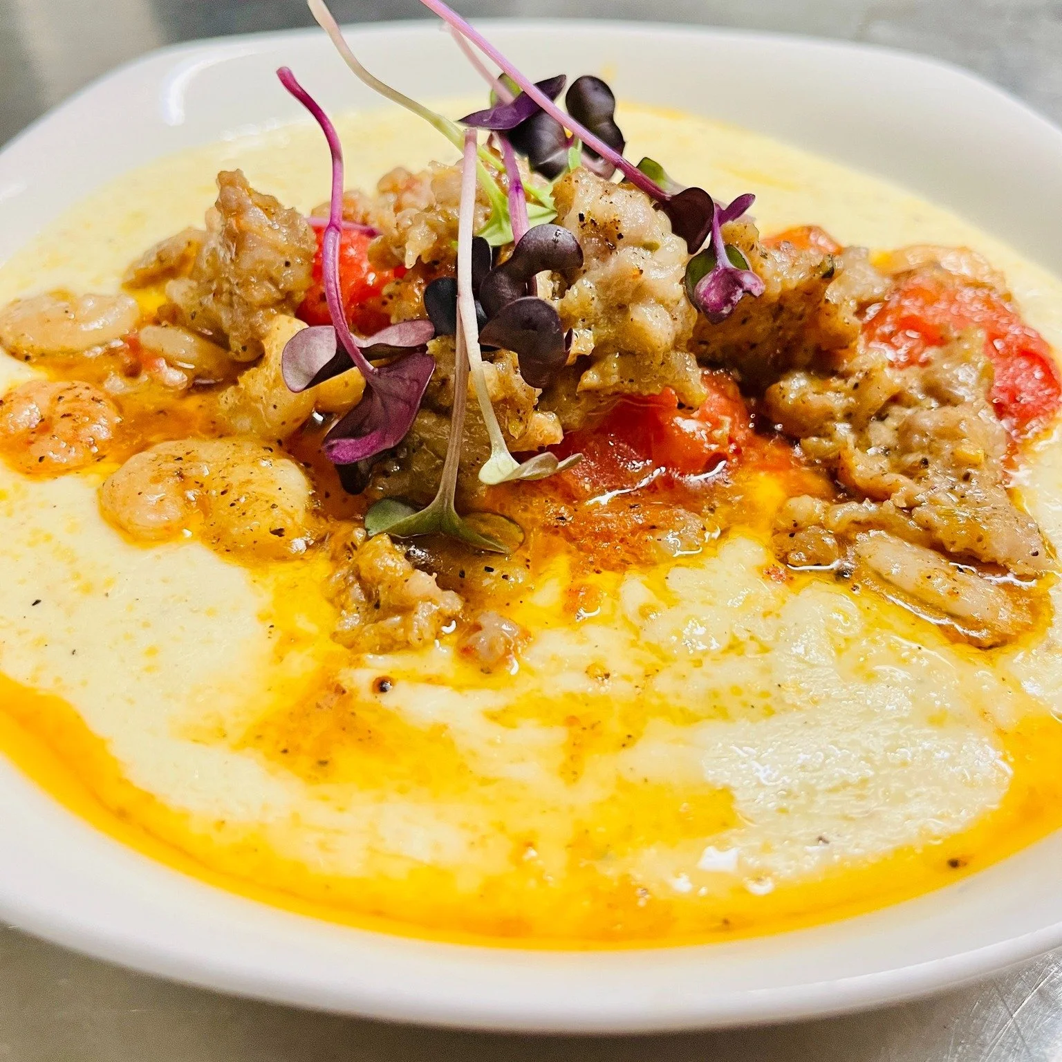 When the weather turns chilly, we turn to comfort &mdash; Italian style. 💛

Our creamy polenta is pure happiness in a bowl: rich and velvety, topped with saut&eacute;ed shrimp, savory sausage, roasted tomatoes that burst with flavor and a touch of g