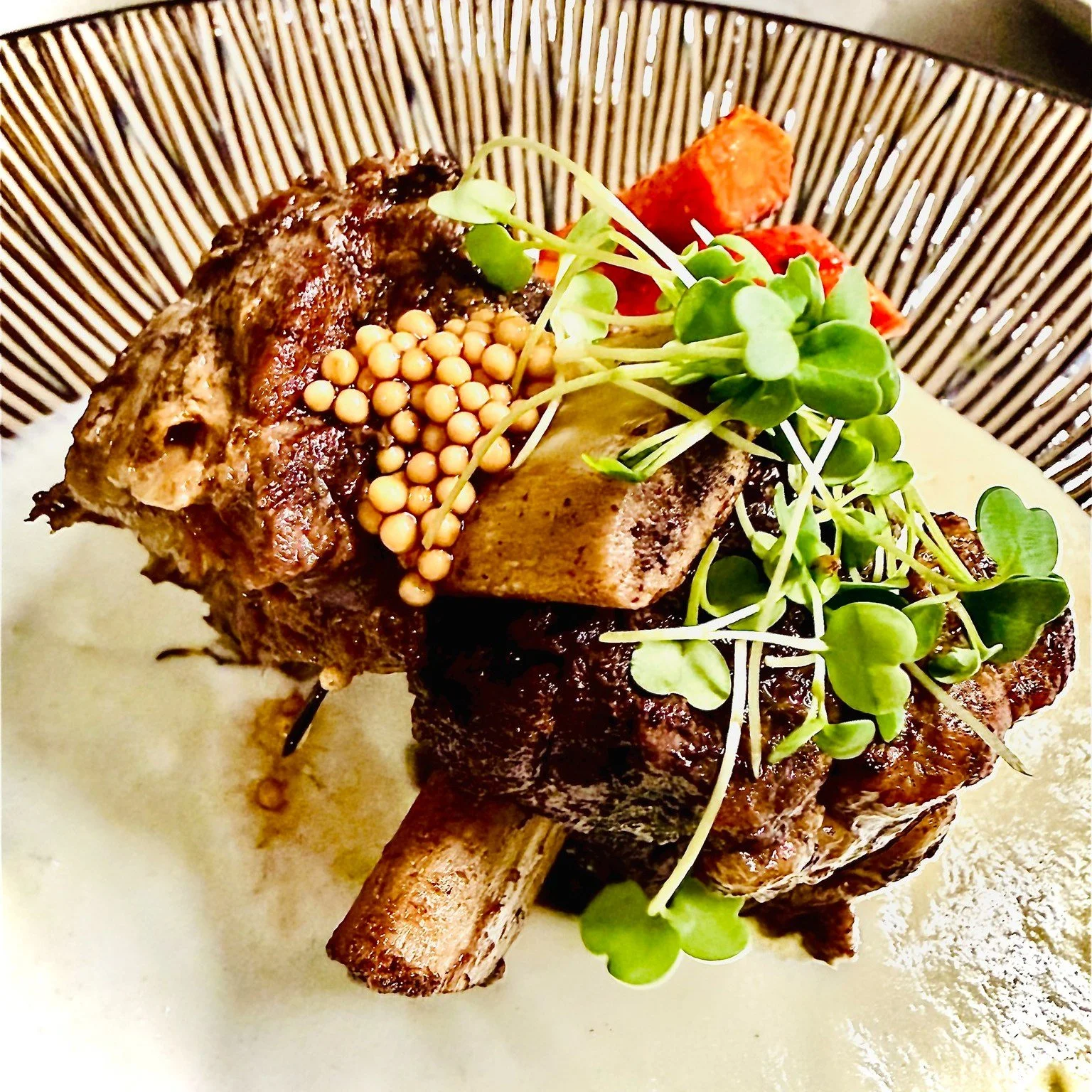 Some dishes are worth the wait.

Our braised bison short ribs, slow cooked until they are tender enough to fall off the bone, resting on a delicate, velvety cauliflower pur&eacute;e.

Sweet honey-roasted carrots and bright pickled mustard seeds bring