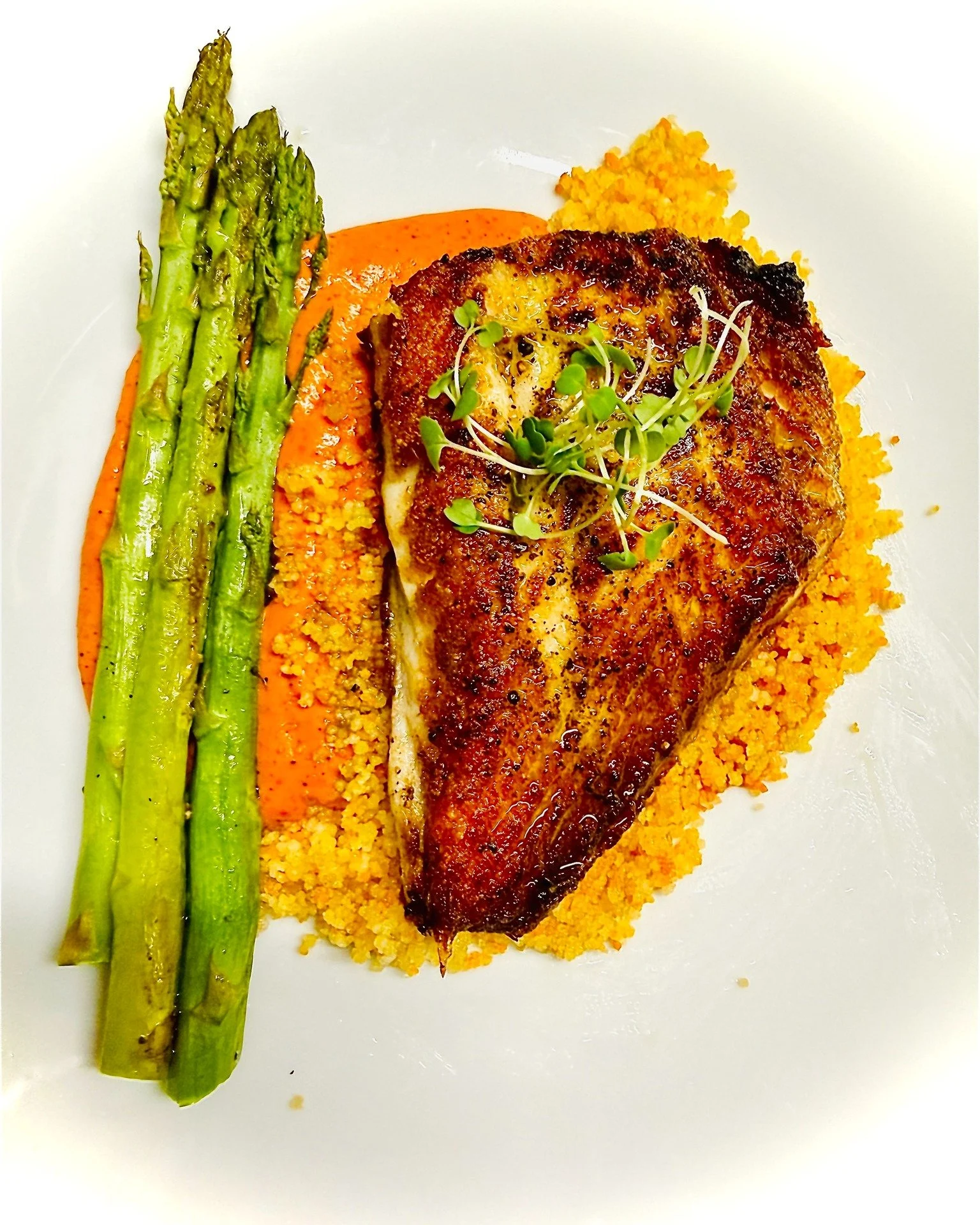 Golden. Crisp. Delicate.

Our flounder fillet is seared just right&mdash;light, flaky and finished with that perfect edge of crunch. It sits on a silky bell pepper pur&eacute;e that brings a quiet sweetness, alongside couscous and roasted asparagus t
