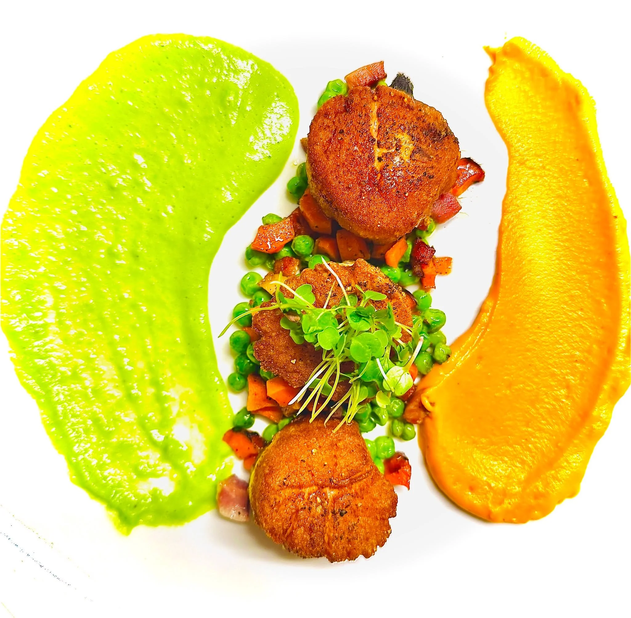This week&rsquo;s scallops from Sam Rust Seafood feel like a quiet celebration of spring&rsquo;s color and sweetness. 

Seared until they blush golden, they are served with twin pur&eacute;es&mdash;vibrant pea and silky carrot&mdash;a pairing that fe