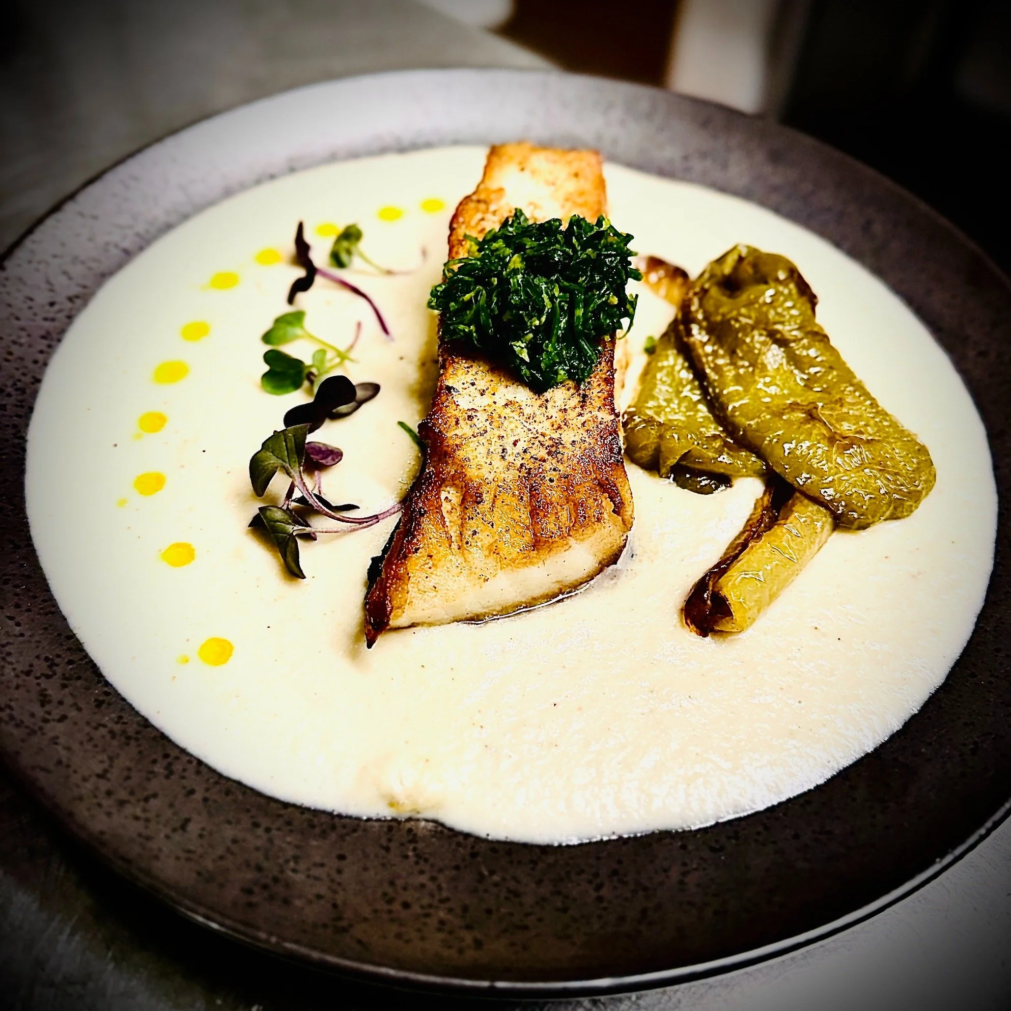 Some dishes don't ask for your attention.
They quietly earn it.

Our fish this week is a beautiful halibut fillet, delicately pan-seared and served over a silky onion soubise&mdash;sweet, velvety and comforting in the most elegant way. Roasted sweet 