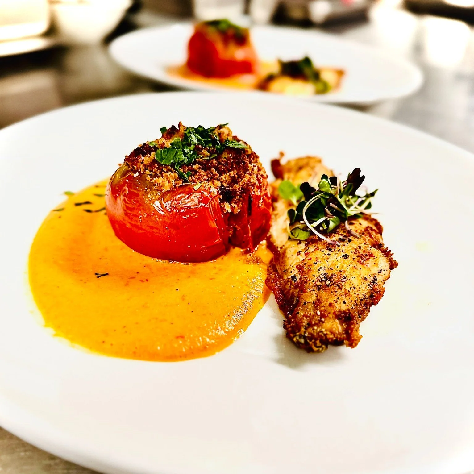 This is what summer tastes like at Ambrogia.

Black sea bass from Sam Rust Seafood, pan-seared until beautifully crisp, resting in a delicate onion and tomato sauce with fresh heirloom tomatoes from Copper Cricket Farm. The tomatoes are filled with h