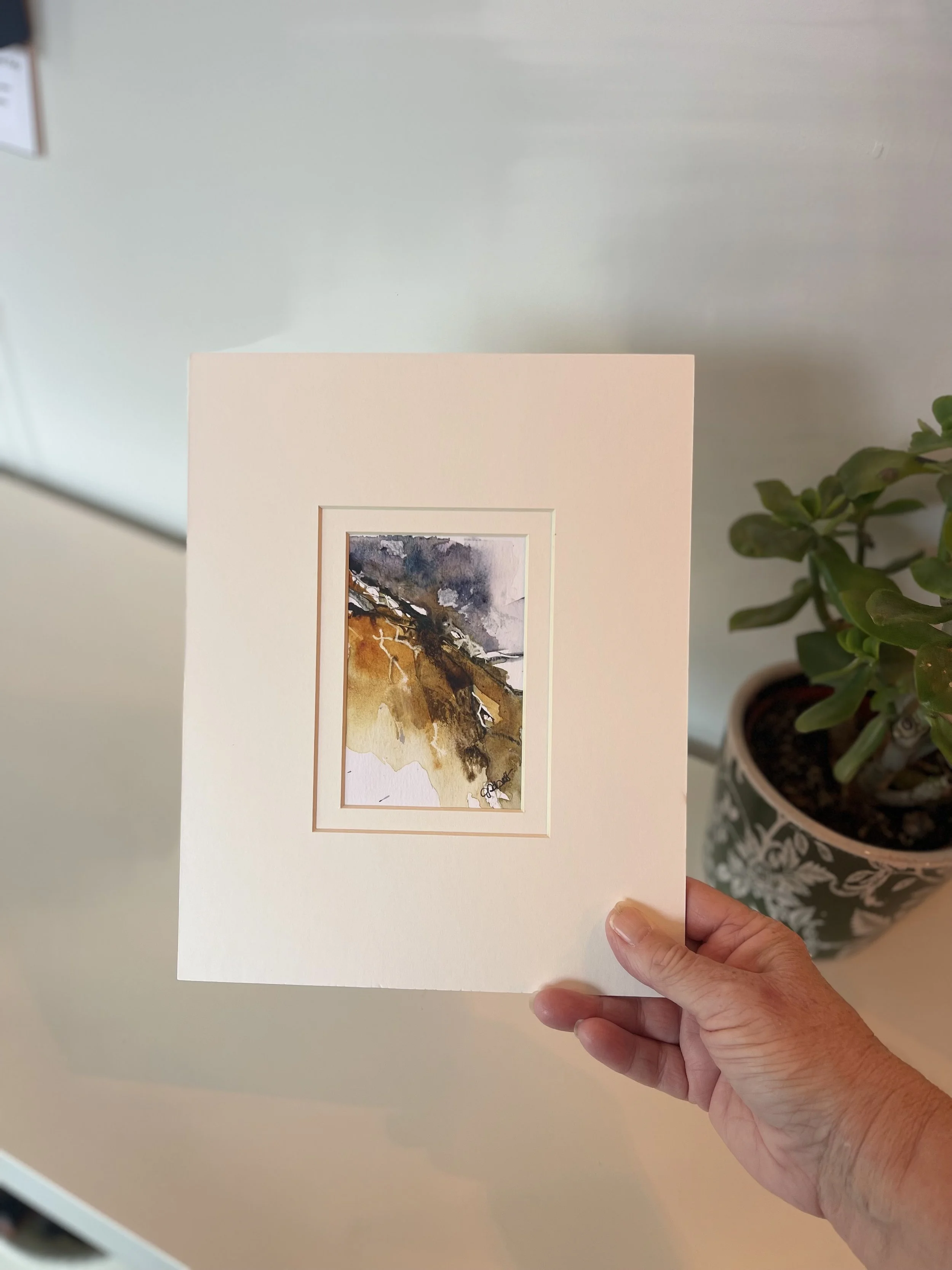 wind-traces-etched-stone-painting-held-in-hand-size-reference.jpg