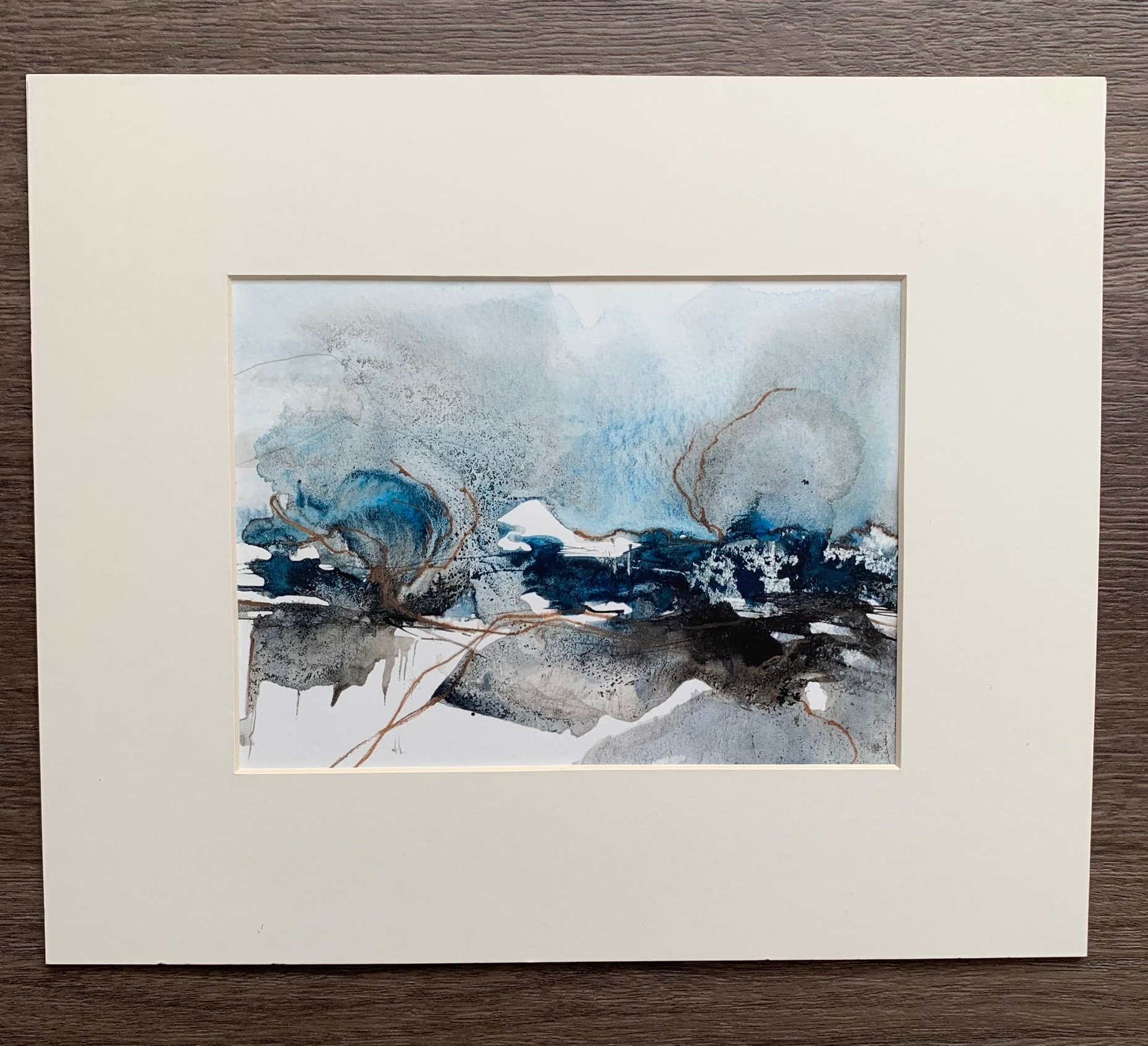 An expressive landscape painting in shades of blues, greys and white with ochre highlights