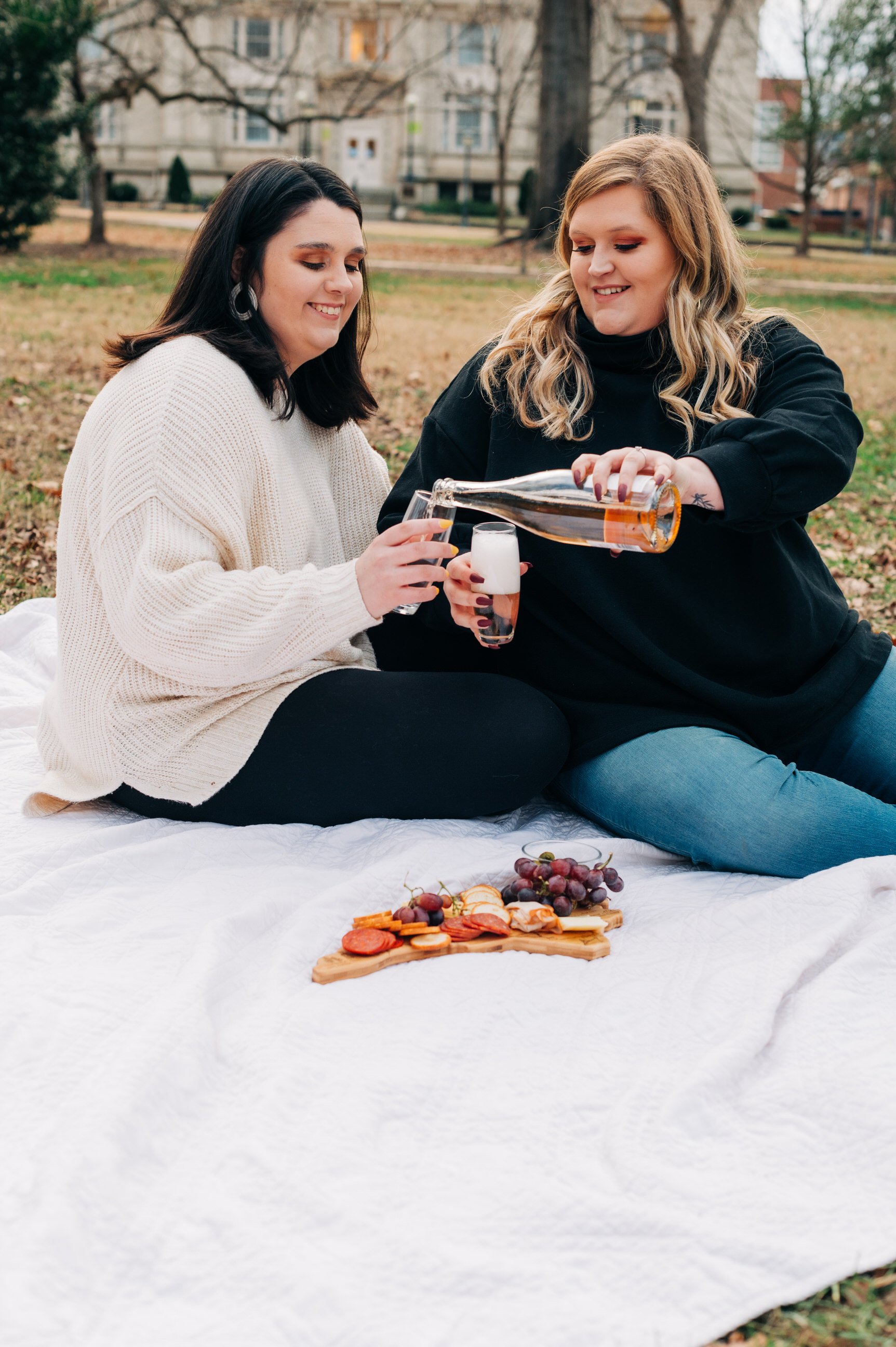  couple sharing charcuterie board picnic 