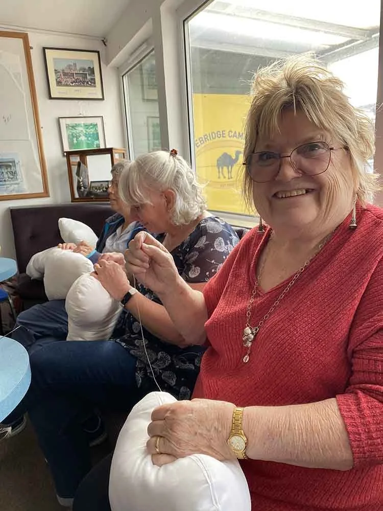Perfect hug sewers sitting at a table sewing at the camels rugby club in wadebridge