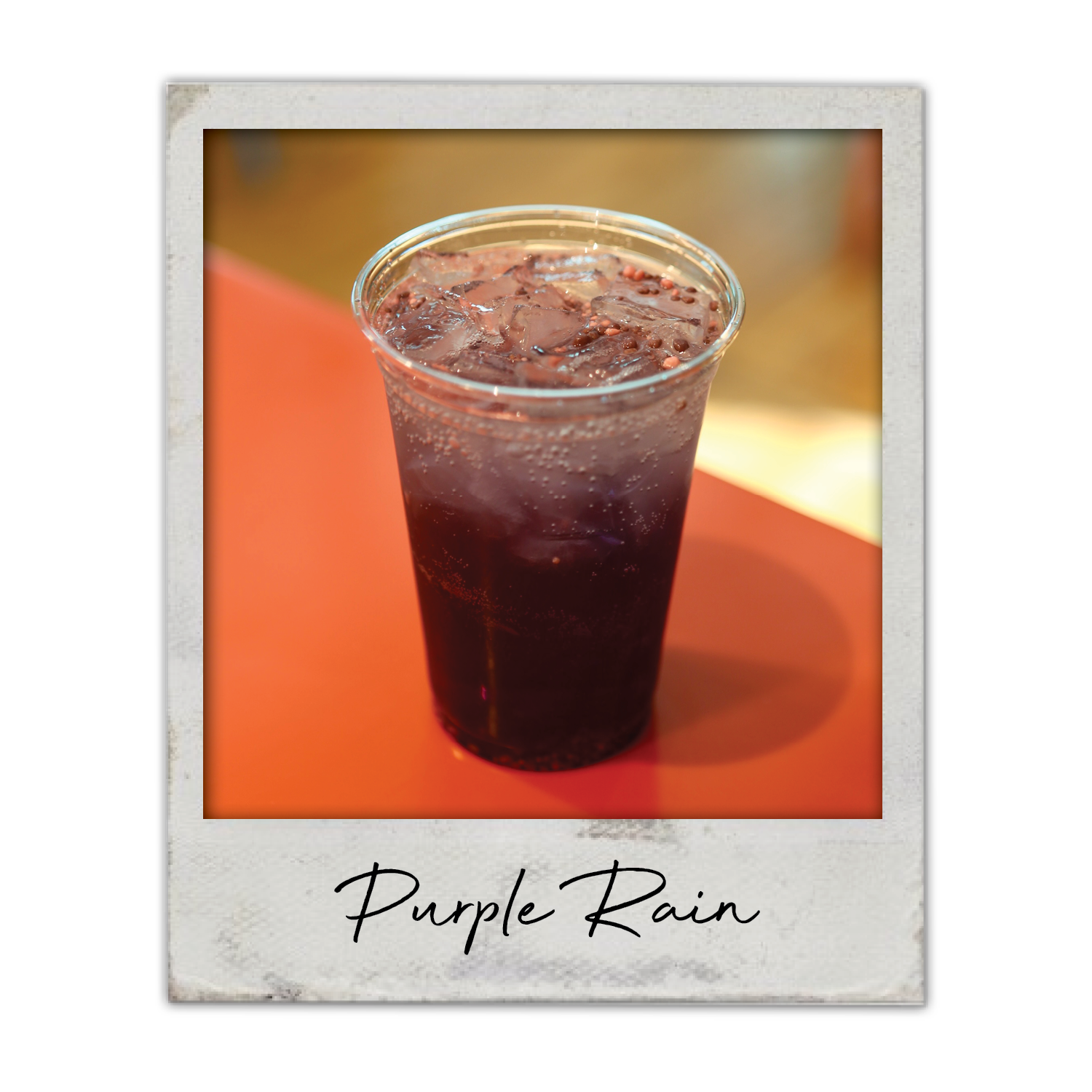 Purple Rain | The Breakfast Club USA, A dark berry energy infusion served over ice in a clear cup.