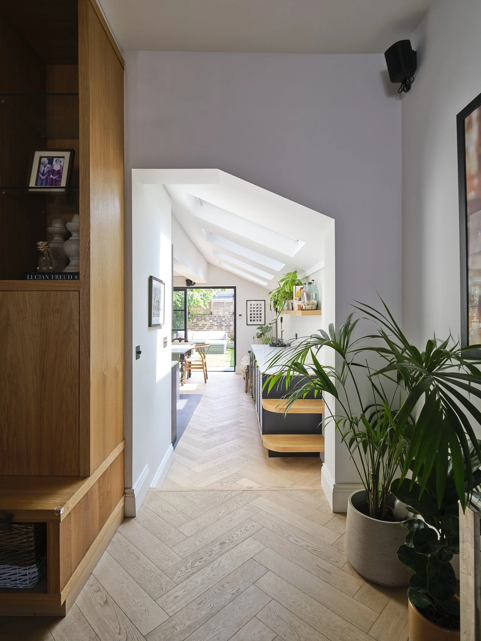 Herringbone wood flooring with bespoke joinery and skylights