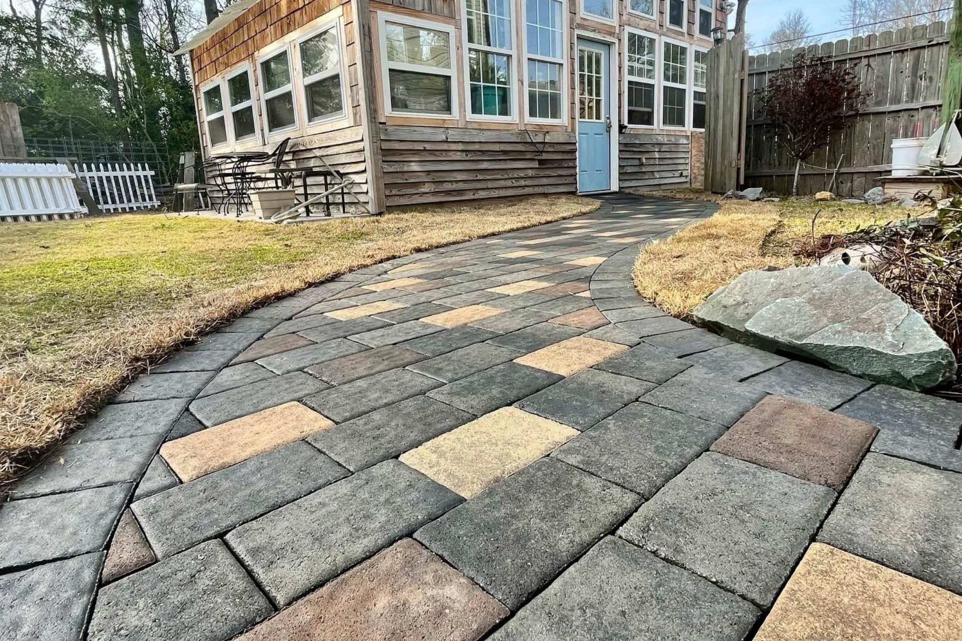 multi-colored paver walk way leading to a home