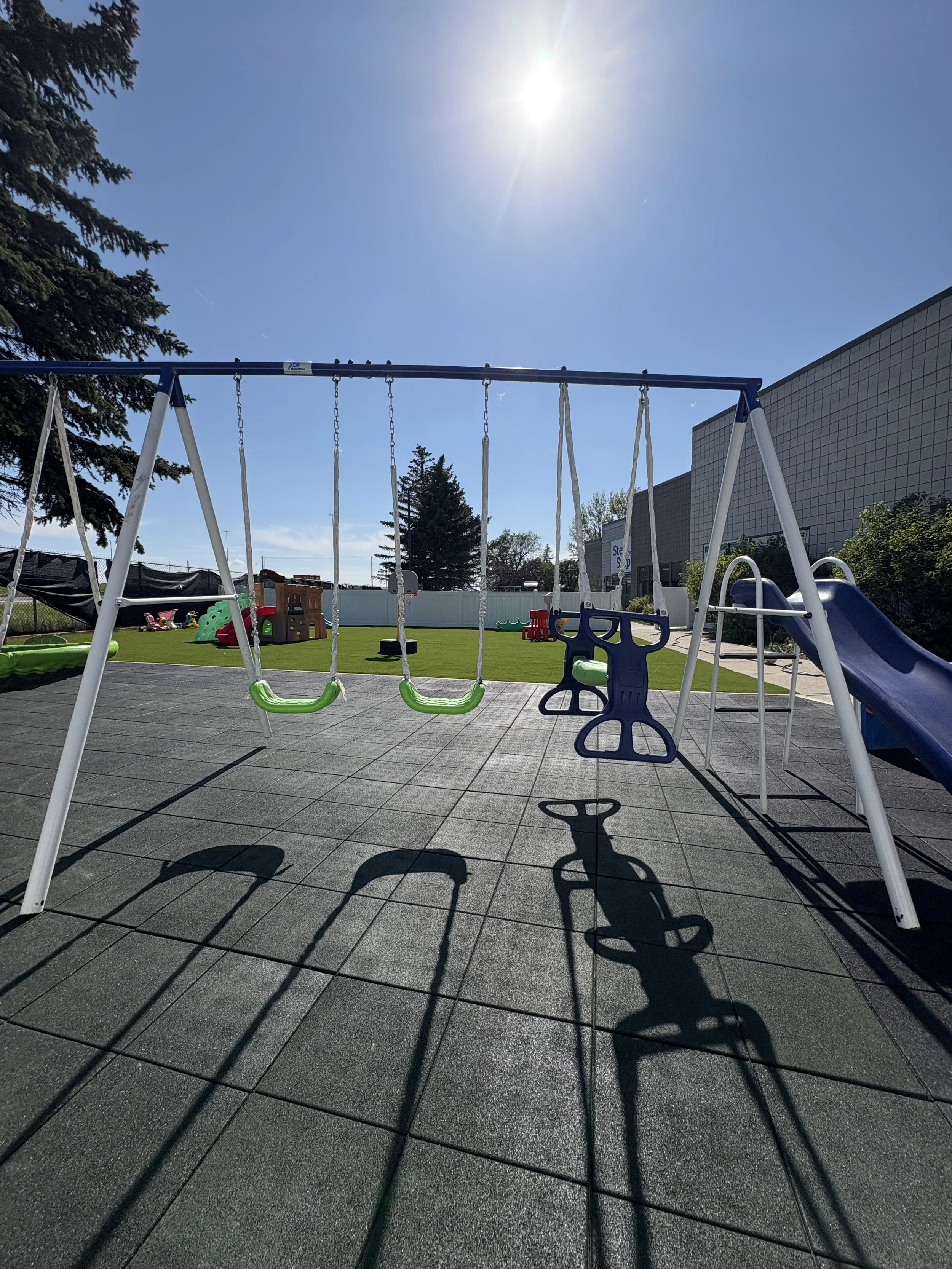 Our spacious accessible play yard is equipped with swing sets, a jungle gym, toy cars, and more to foster a love of outdoor fun. 