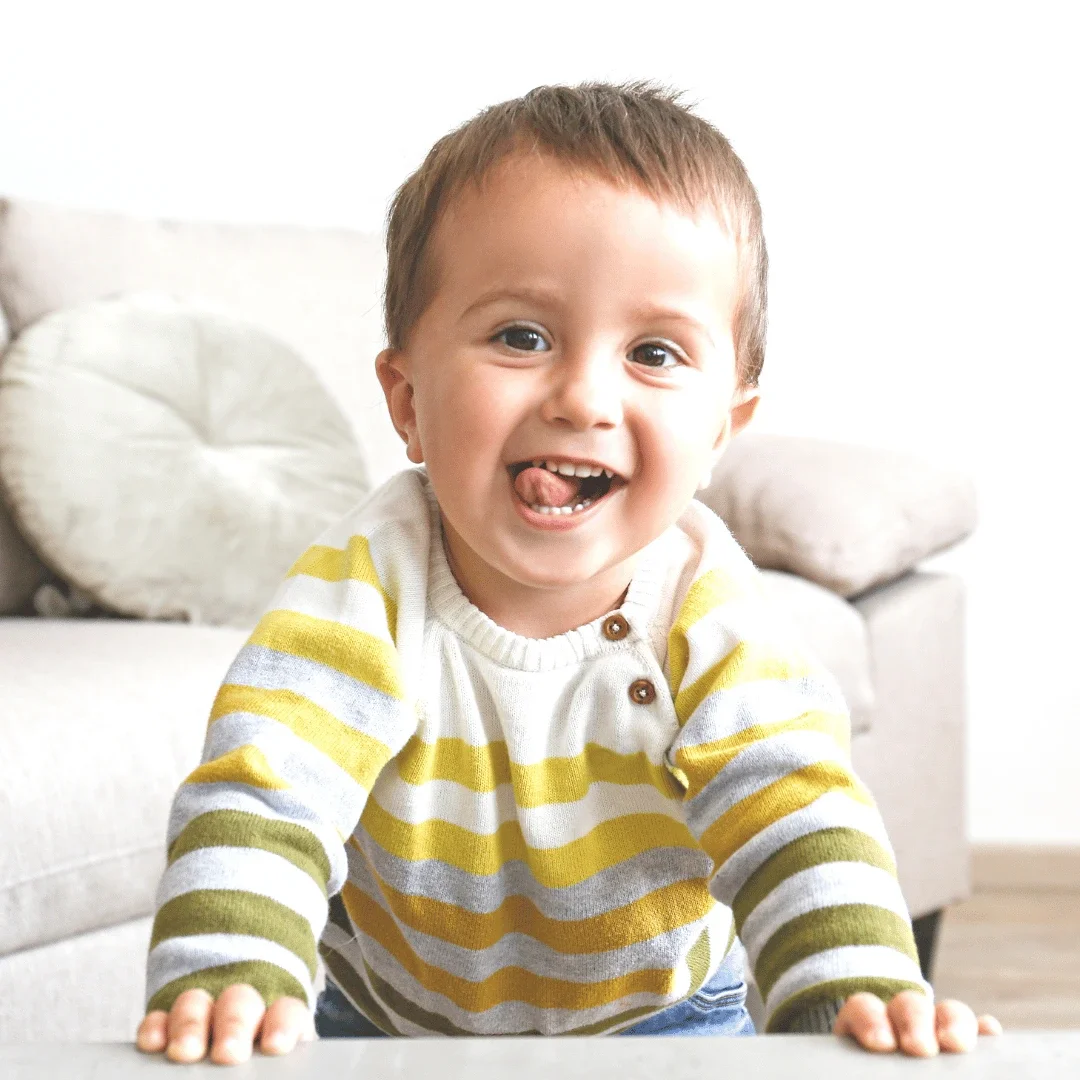 Young child with big smile at home.
