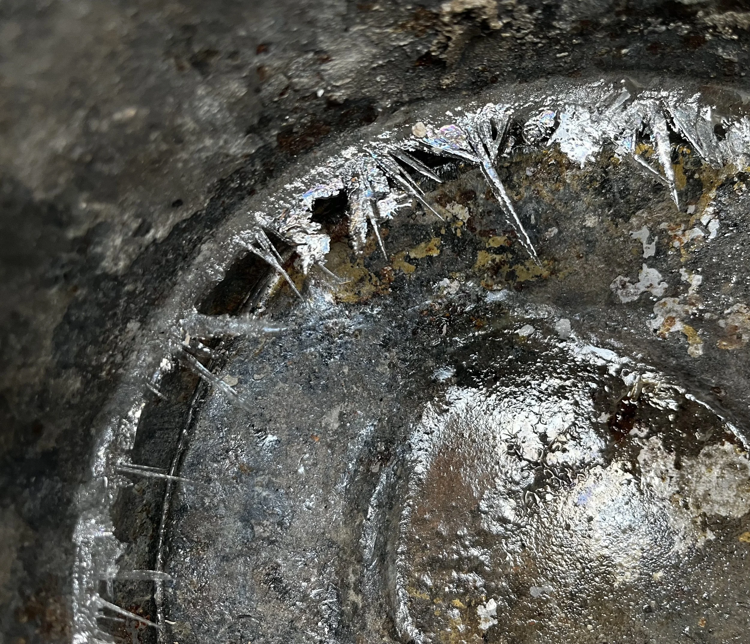 The bottom of a steel pail I was using to gather water. The water went in another pail on top of a grate over a fire. Then two pieces of antler I was wanting to use as knife handles went in the boiling water for half an hour. Boiling antlers allows t
