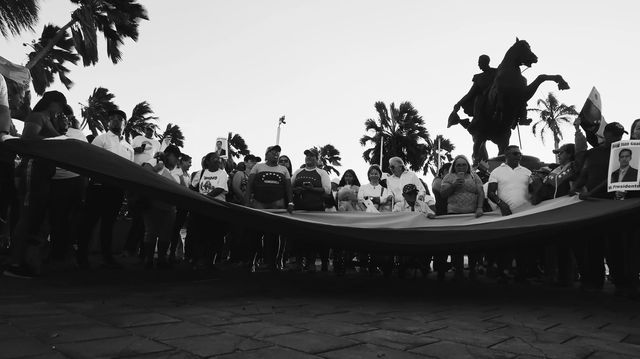 A group of people gathered outdoors during fieldwork, seen against the sky.