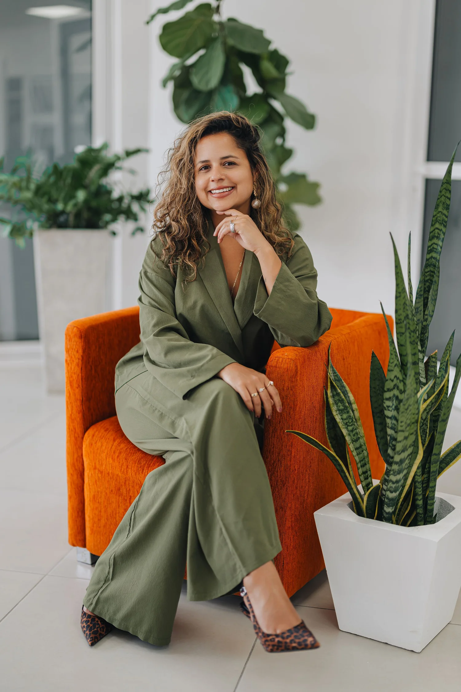 Tiarra Simon, seated in an orange chair.
