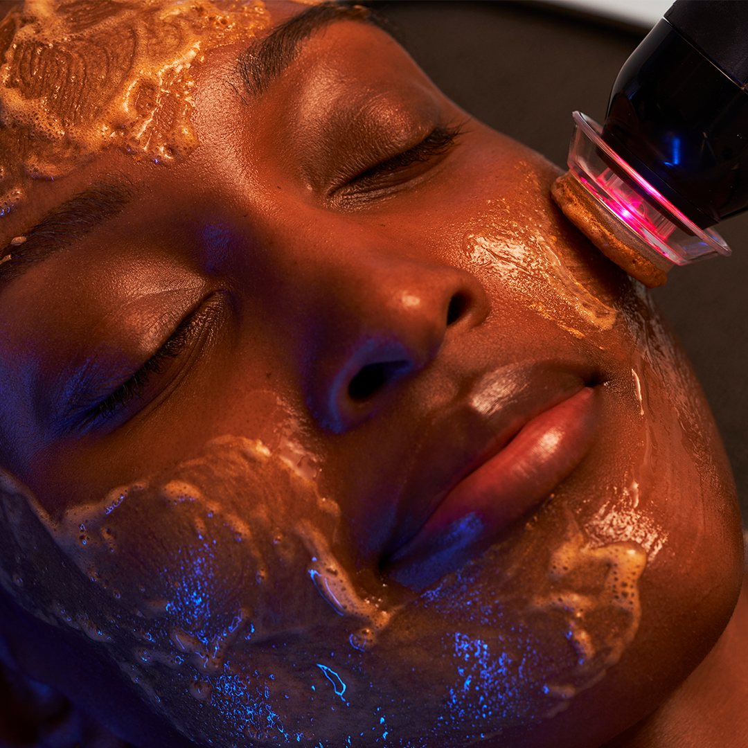 Client receiving a Glo₂Facial™ advanced skincare treatment at Crystal Gayle Aesthetics